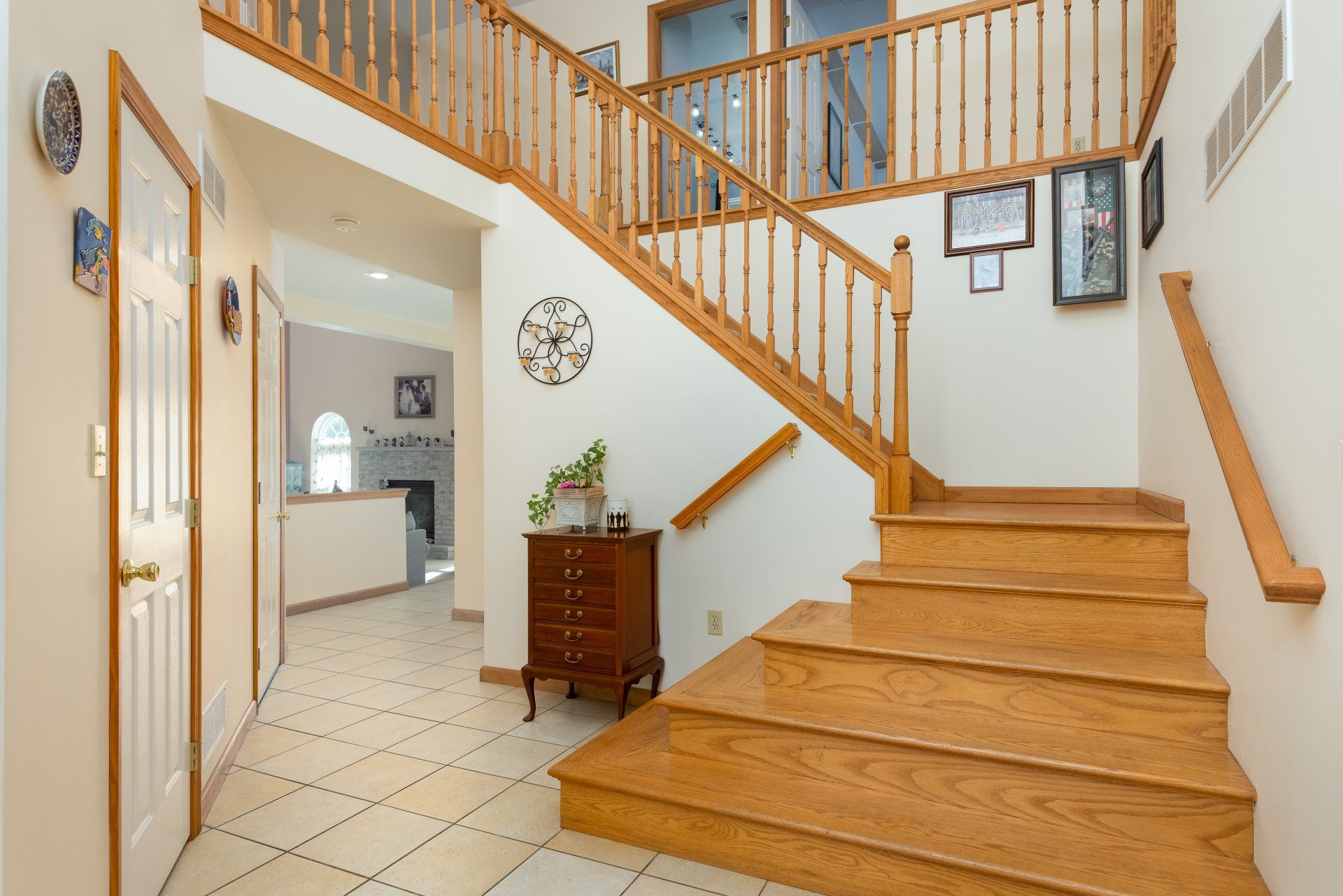 A wooden staircase in a house with a clock on the wall