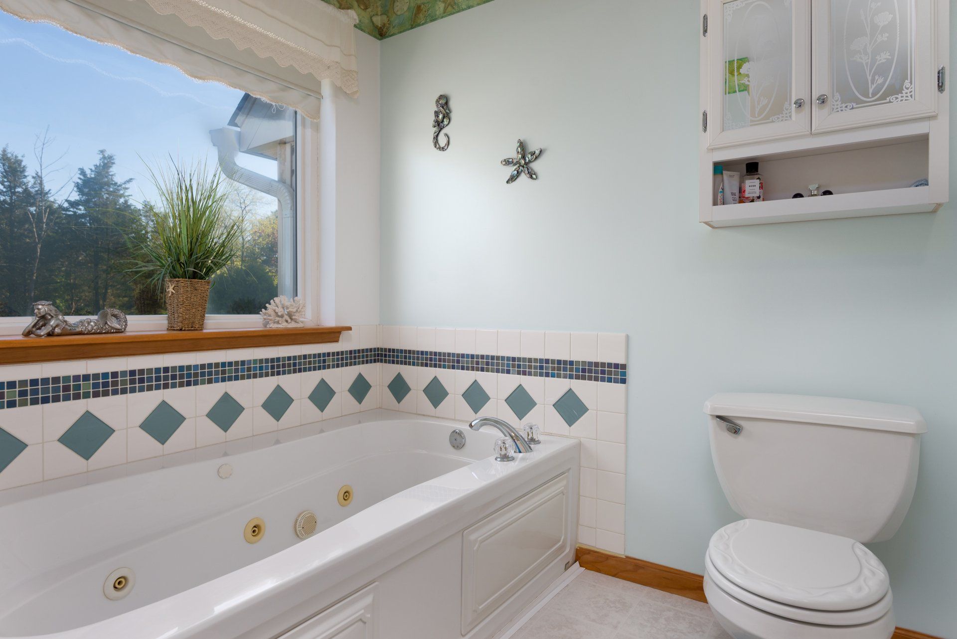 A bathroom with a jacuzzi tub and a toilet