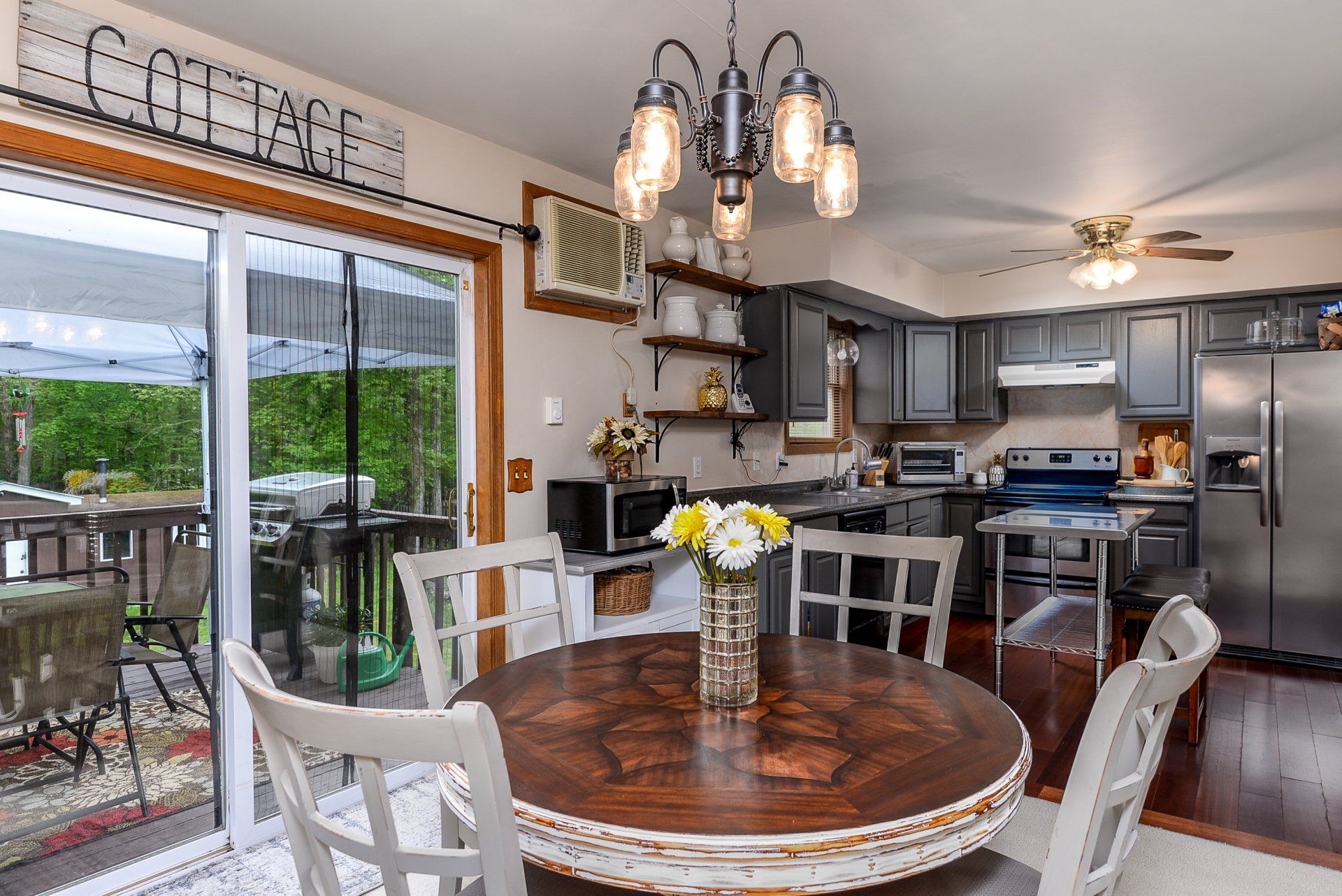 A kitchen with a table and chairs and a sign that says cottage