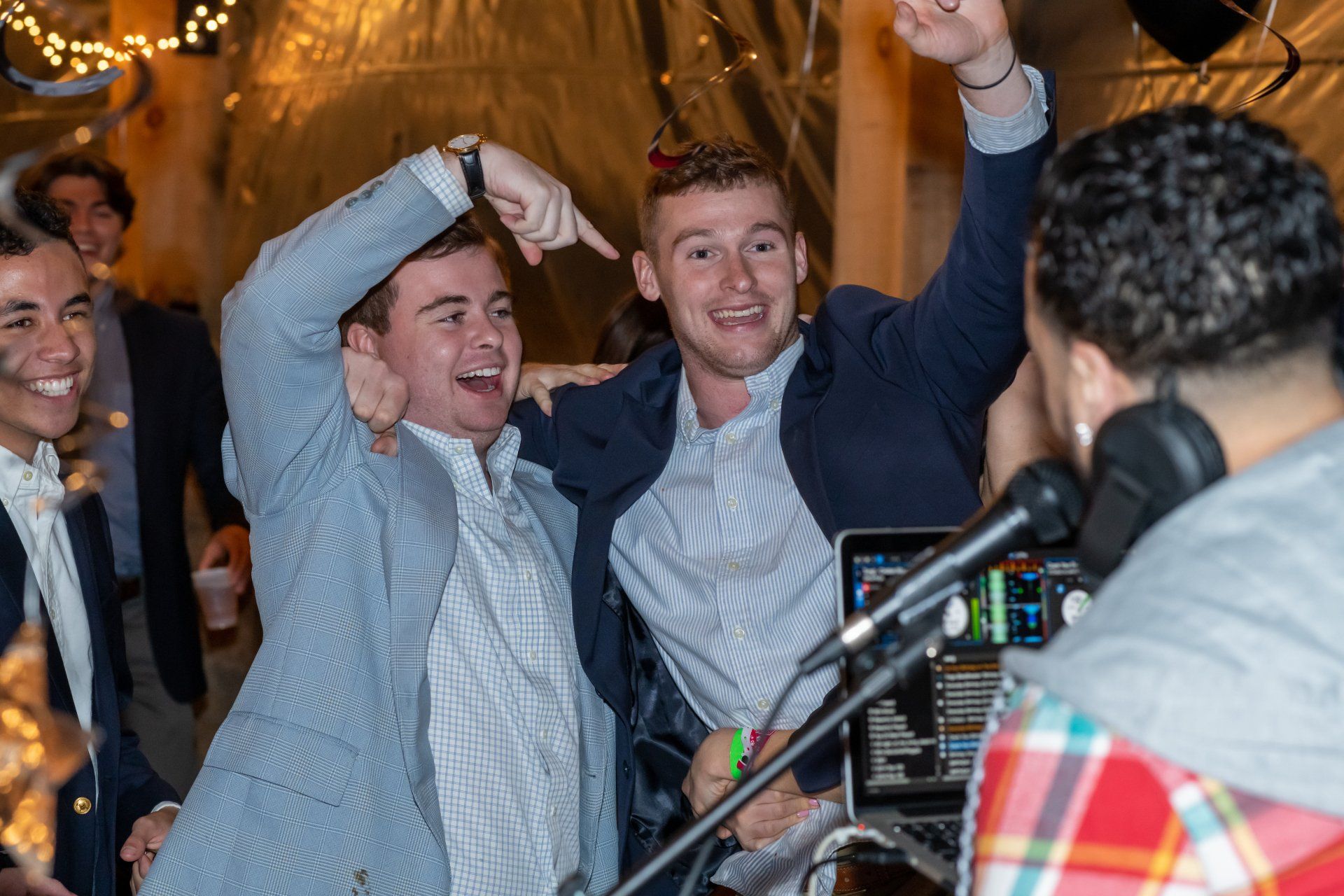 A group of men are posing for a picture at a party.