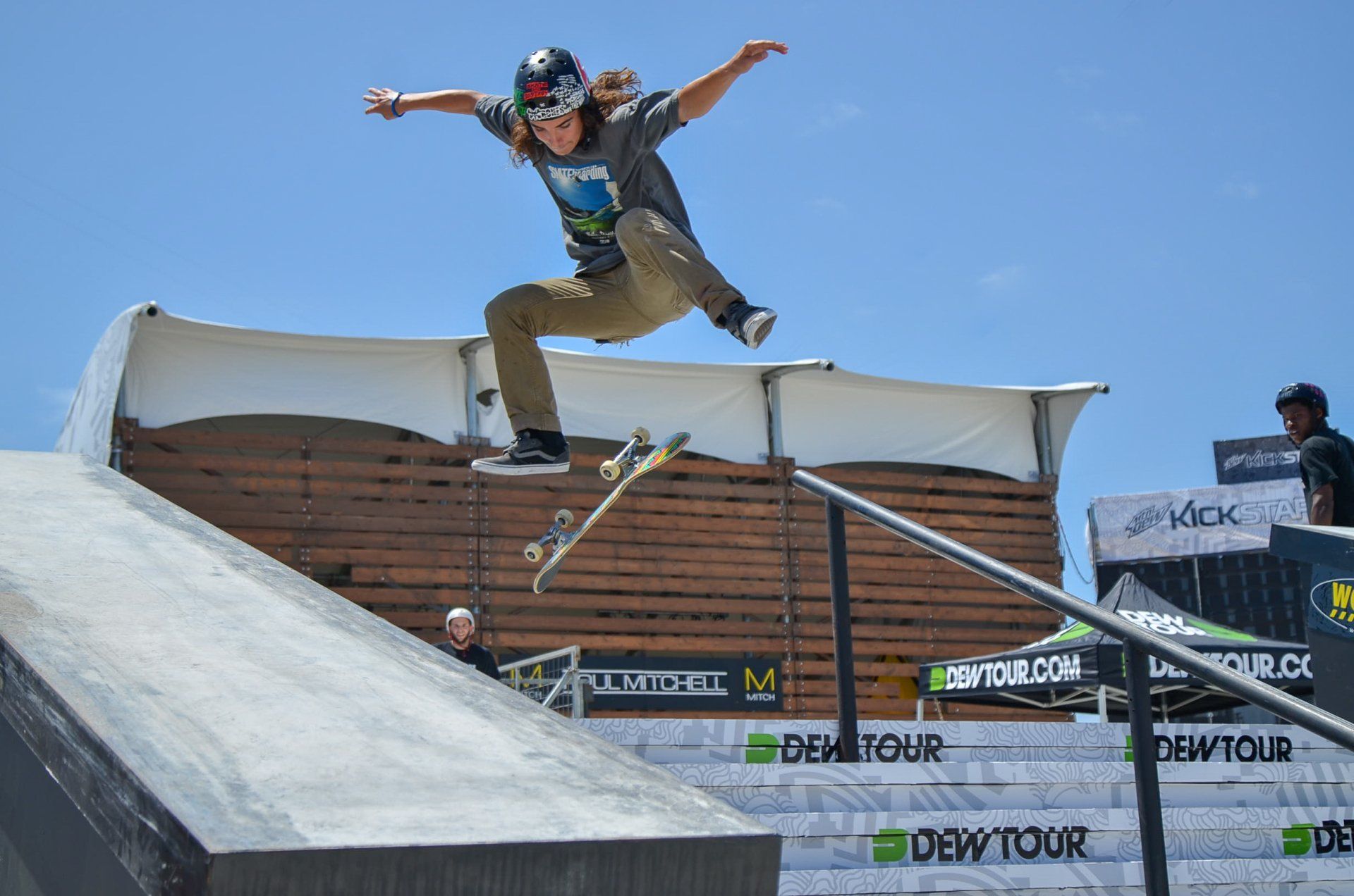A person is doing a trick on a skateboard on a ramp.