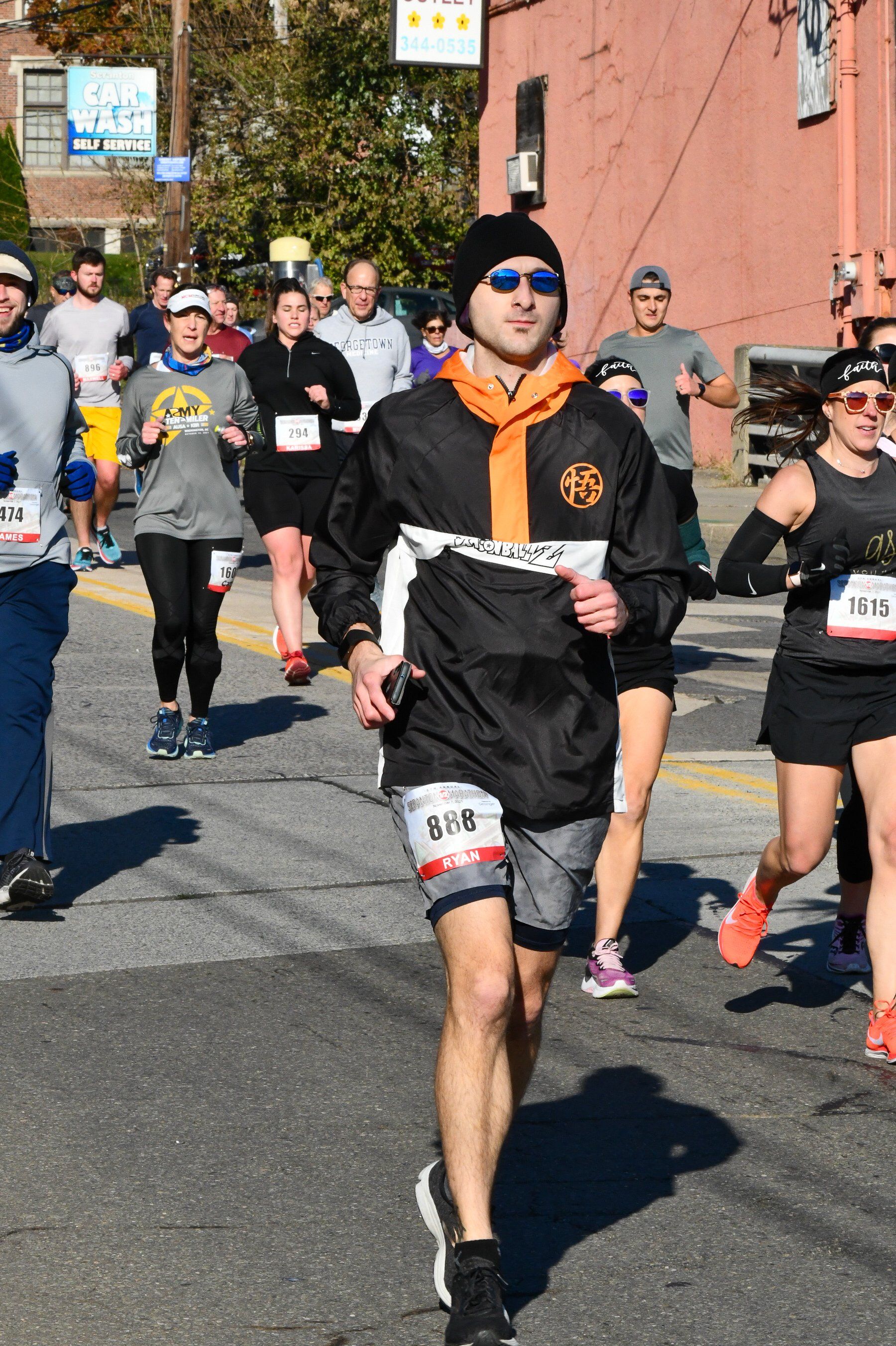 A group of people are running a marathon on a street.
