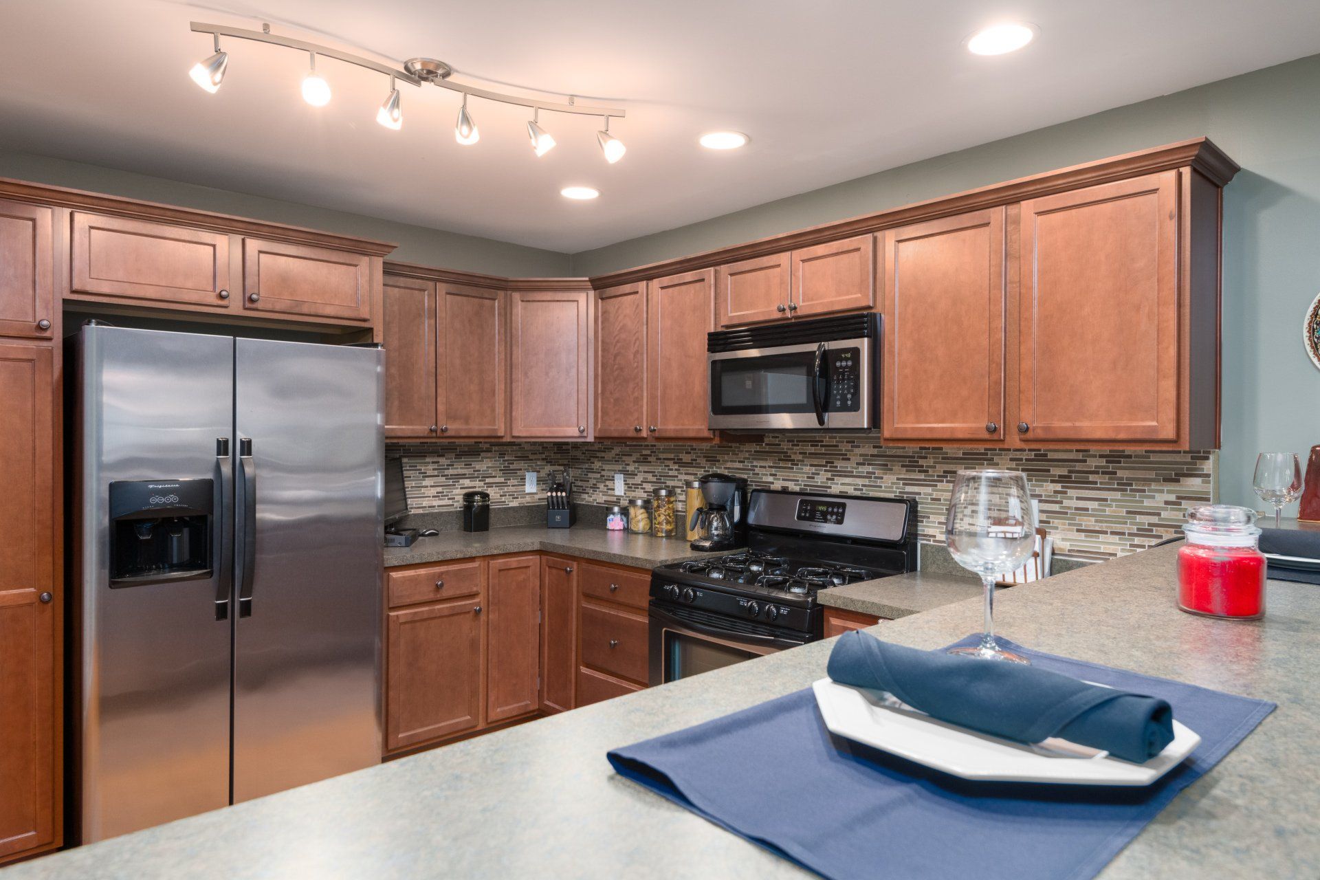 A kitchen with stainless steel appliances and wooden cabinets