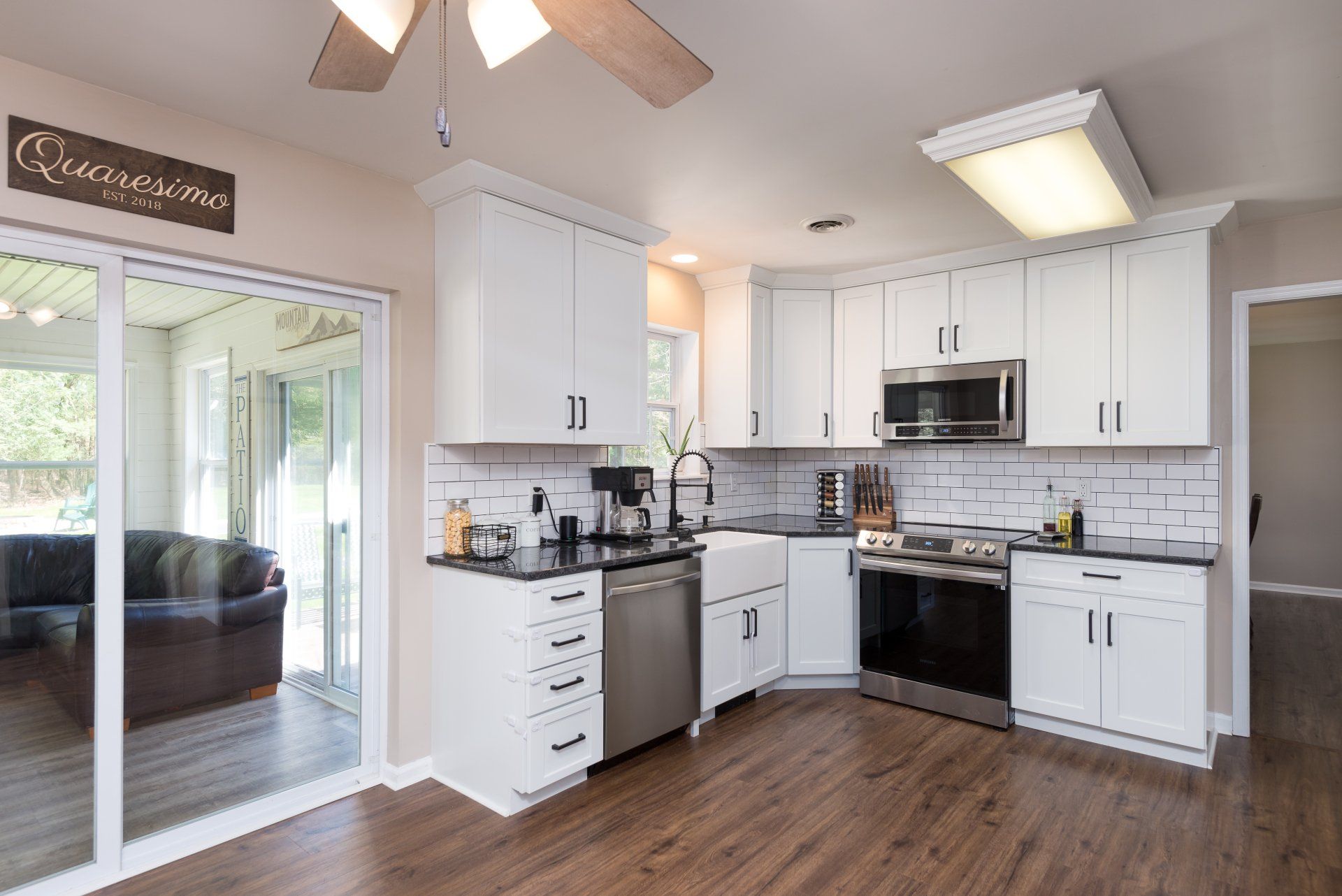 A kitchen with white cabinets and stainless steel appliances