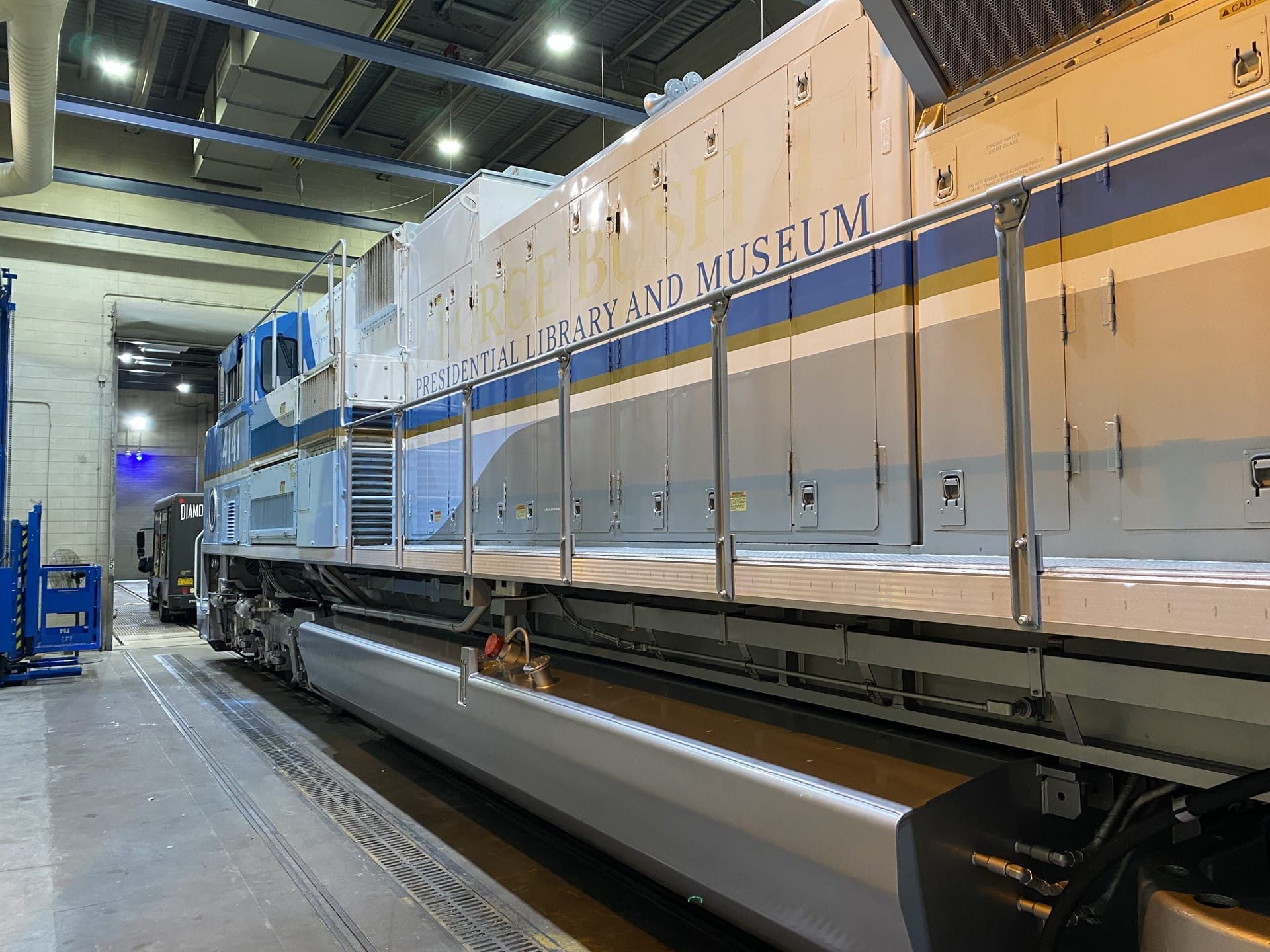 Blue and white train car at the Nevada Northern Railway Museum.  Aisle with safety railings.