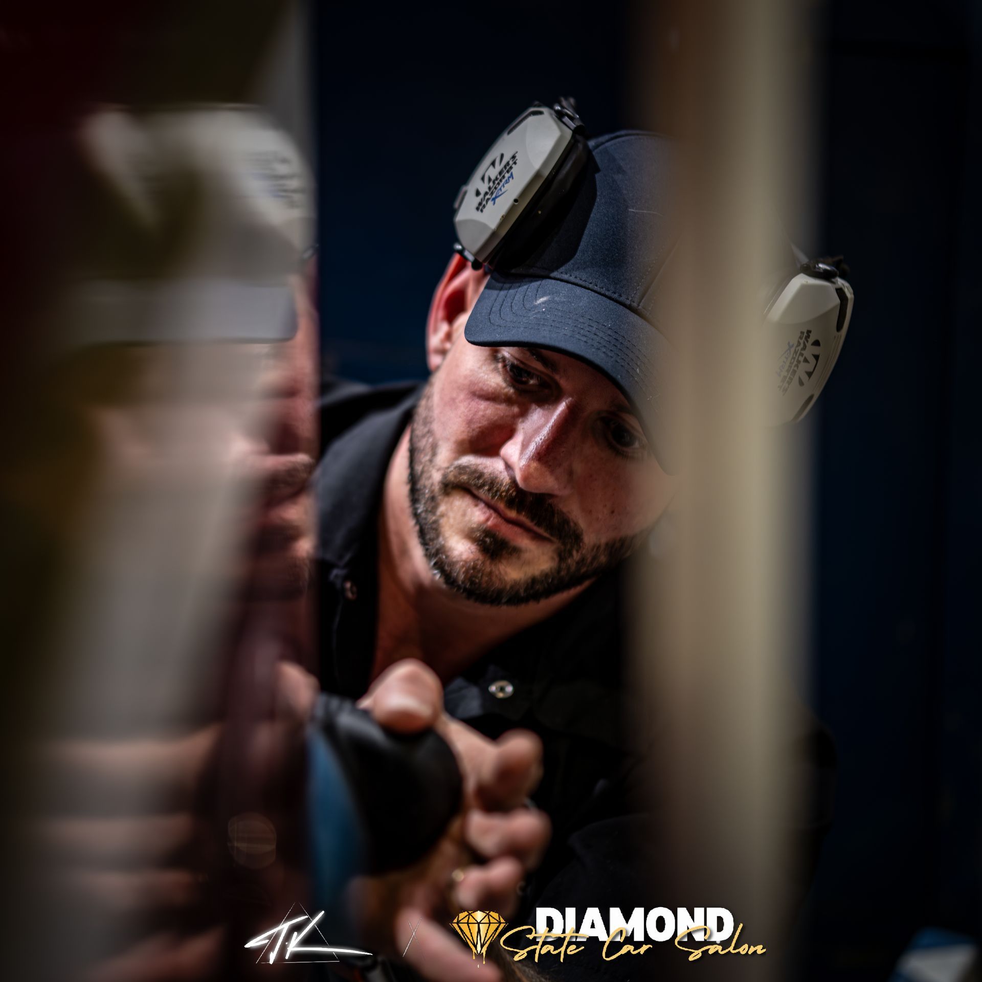 Blue Bentley coupe parked inside a garage with polished concrete flooring.