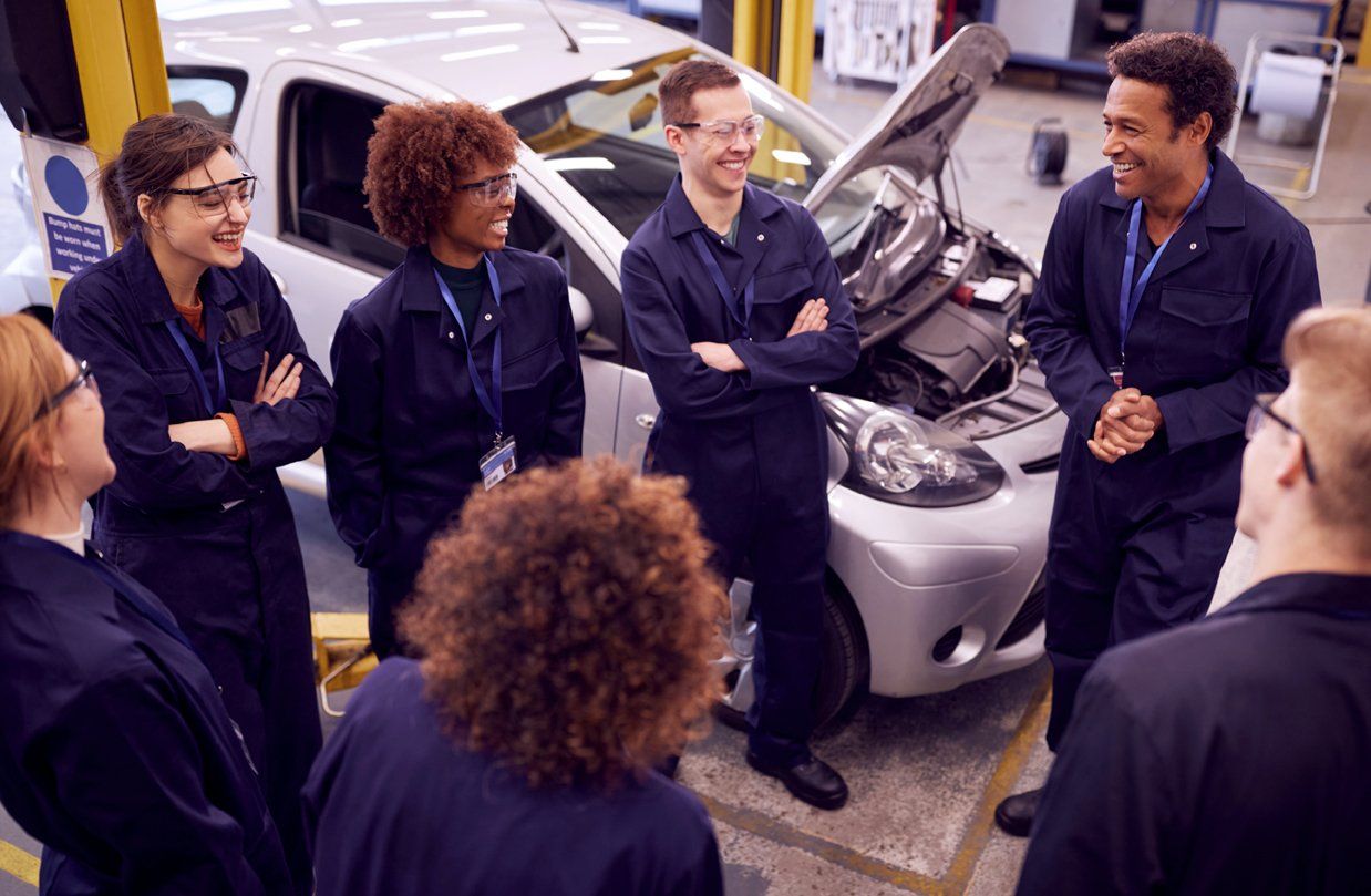 Staff in Garage Discussing Together | Patton's Automotive