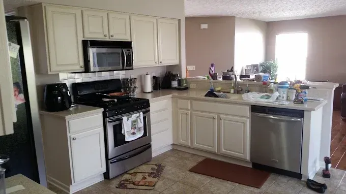 Kitchen with white cabinets, stainless steel appliances, and a countertop.