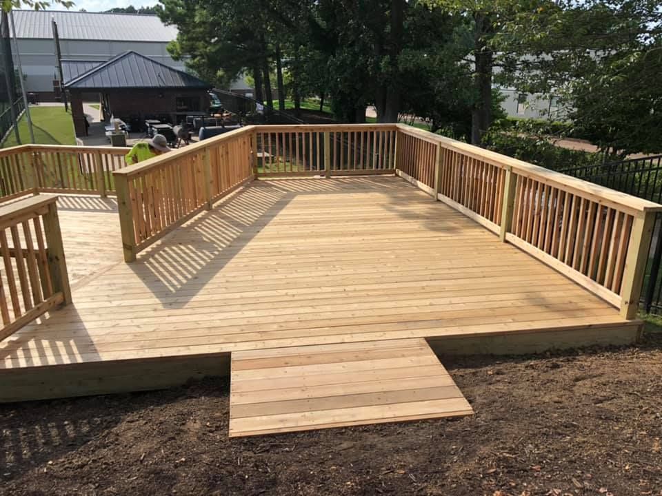 A large wooden deck with a ramp leading to it.