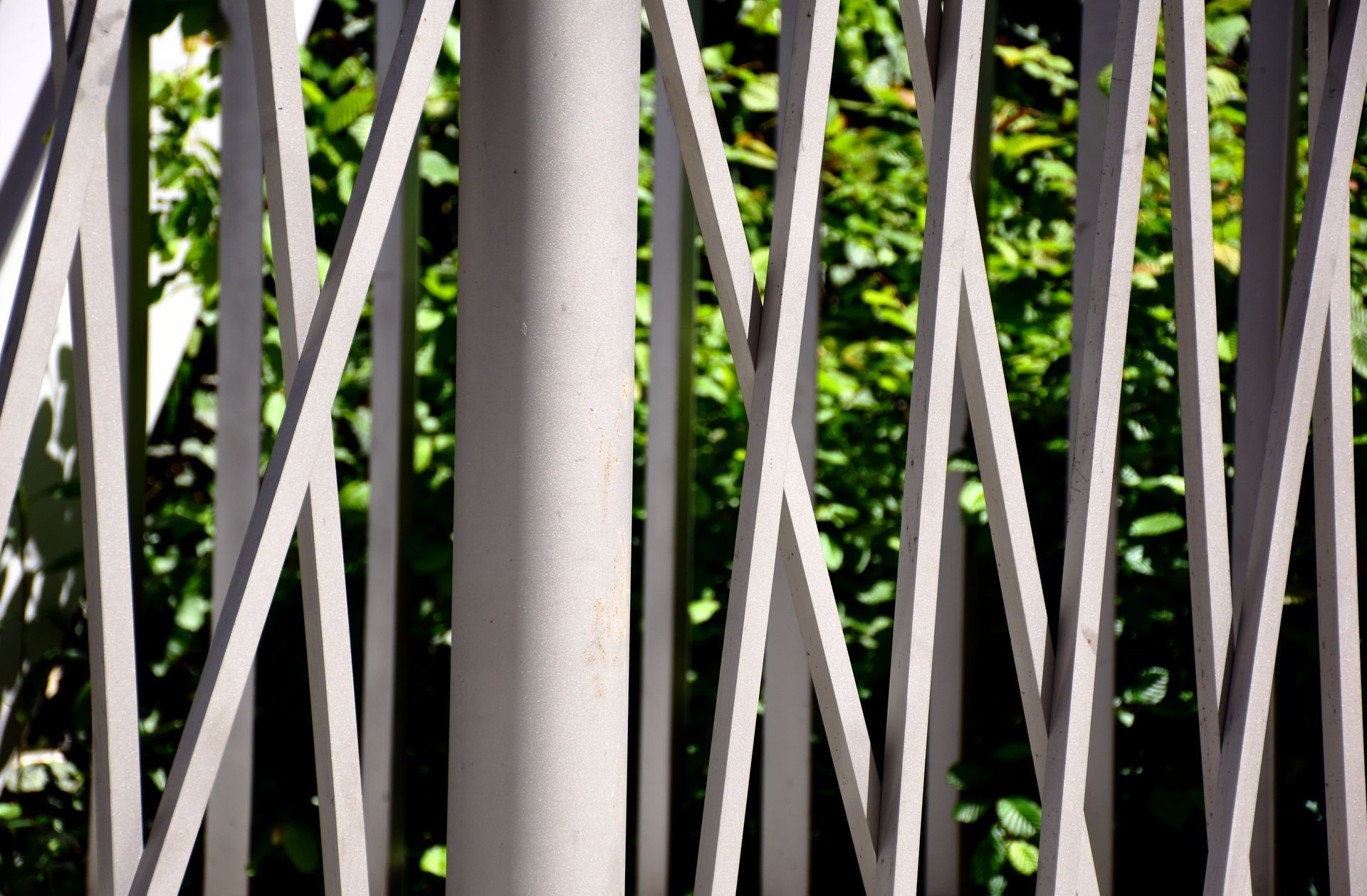 A close up of a fence with trees in the background