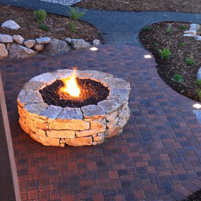Custom Fire Pit — Aerial Shot Of Fire Pit And Landscape Pavers At Dusk in Colorado Springs, CO