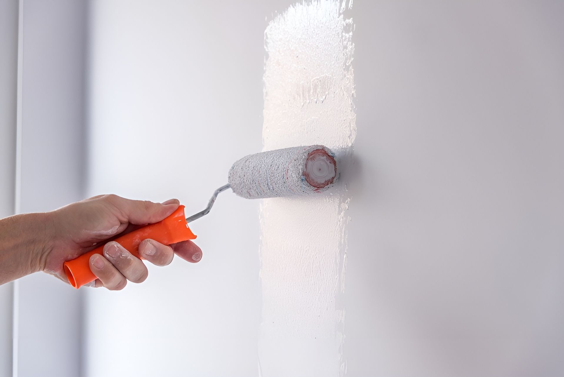 Hand Painting a White Wall with A Paint Roller — Frenchy’s Plaster & Paint in Humpty Doo, NT