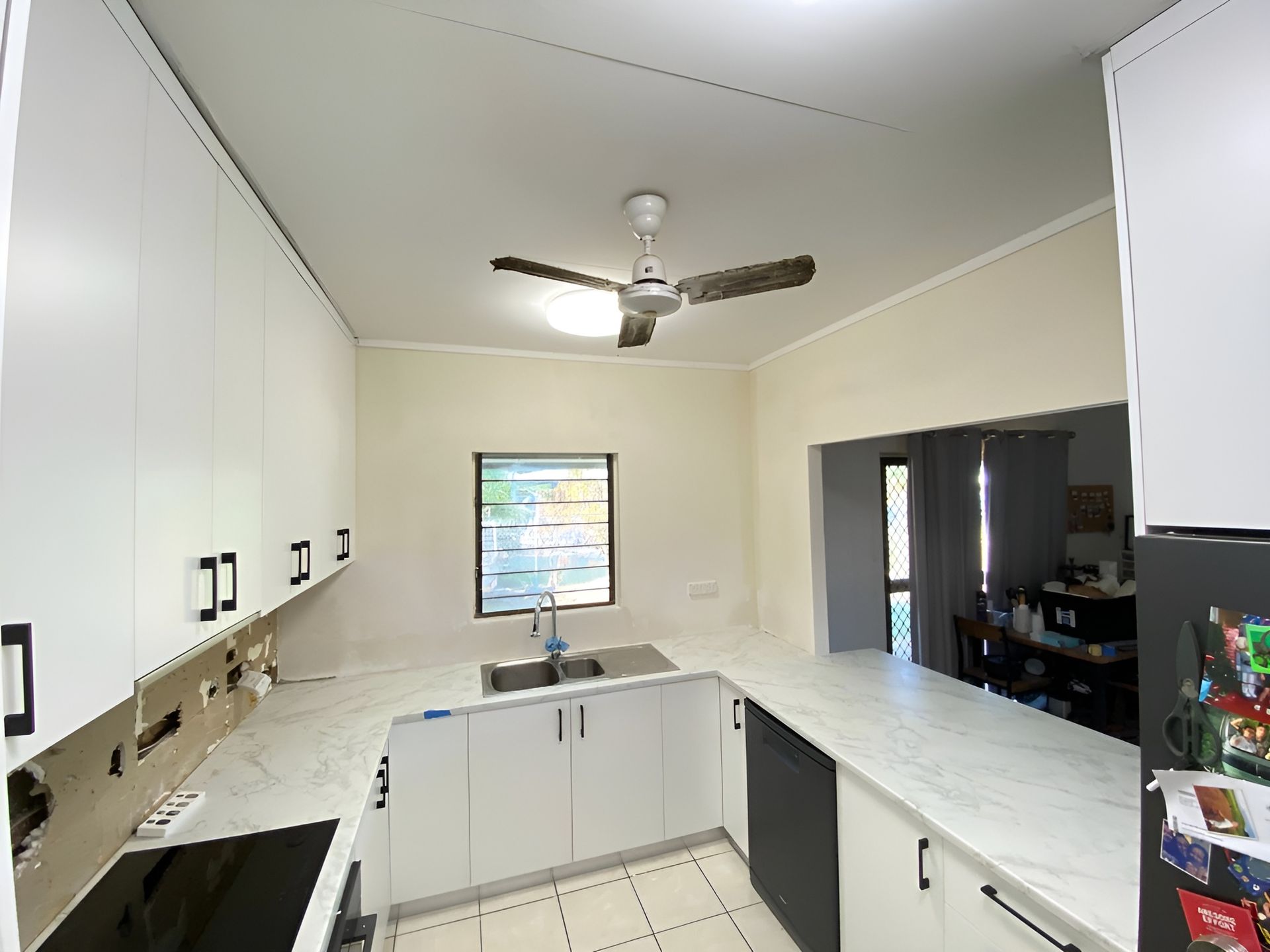 White Kitchen with Countertops, Cabinets, Appliances, and A Ceiling Fan — Frenchy’s Plaster & Paint in Bellamack, NT