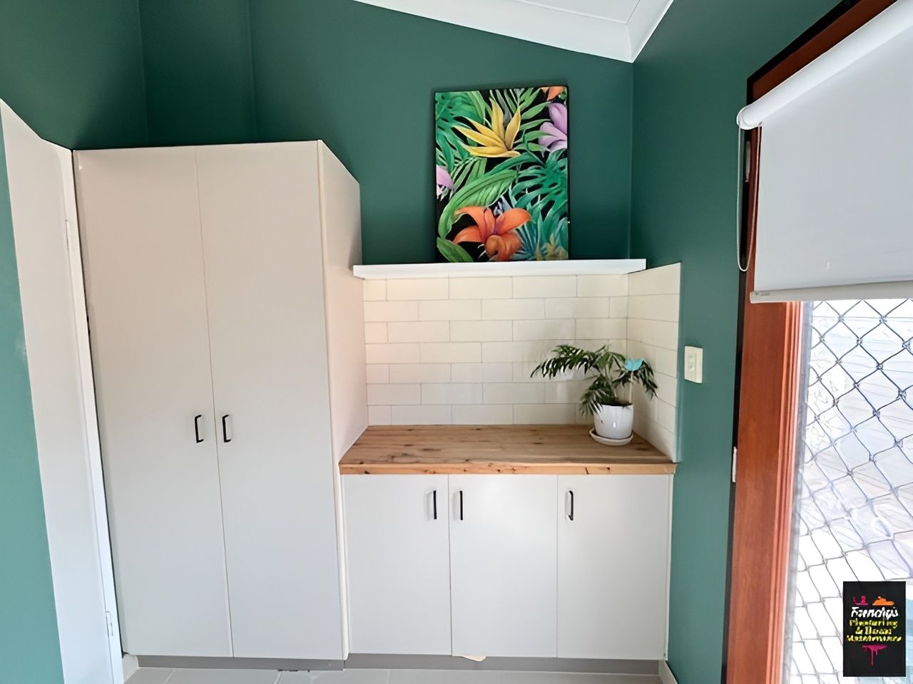 White Cabinets and Wooden Countertop in A Room Painted Teal — Frenchy’s Plaster & Paint in Bellamack, NT