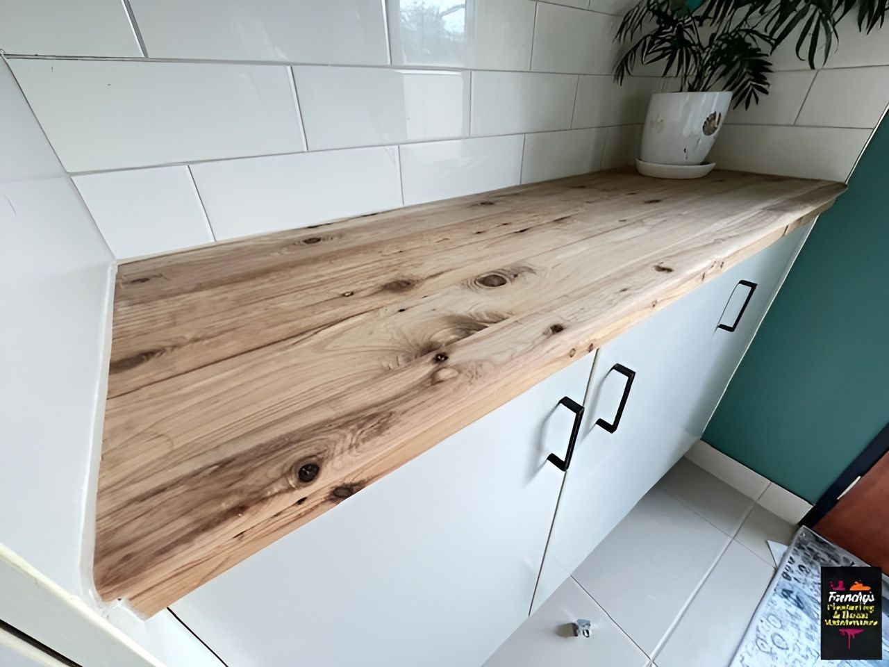 Countertop Over White Cabinets Against White Tiled Wall and Turquoise Wall — Frenchy’s Plaster & Paint in Bellamack, NT