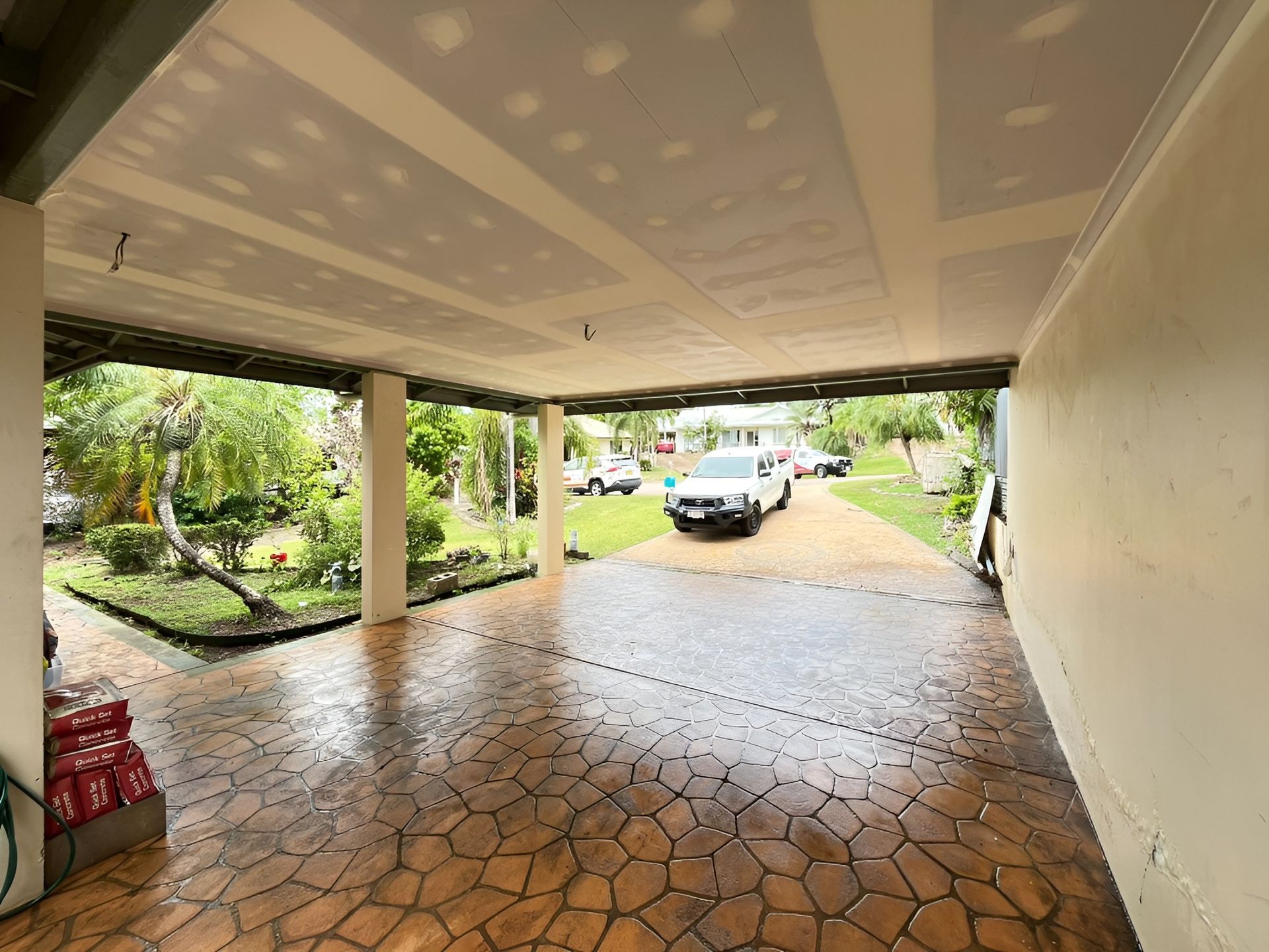 Covered Driveway with Stamped Concrete Floor, Parked White Pickup Truck — Frenchy’s Plaster & Paint in Bellamack, NT