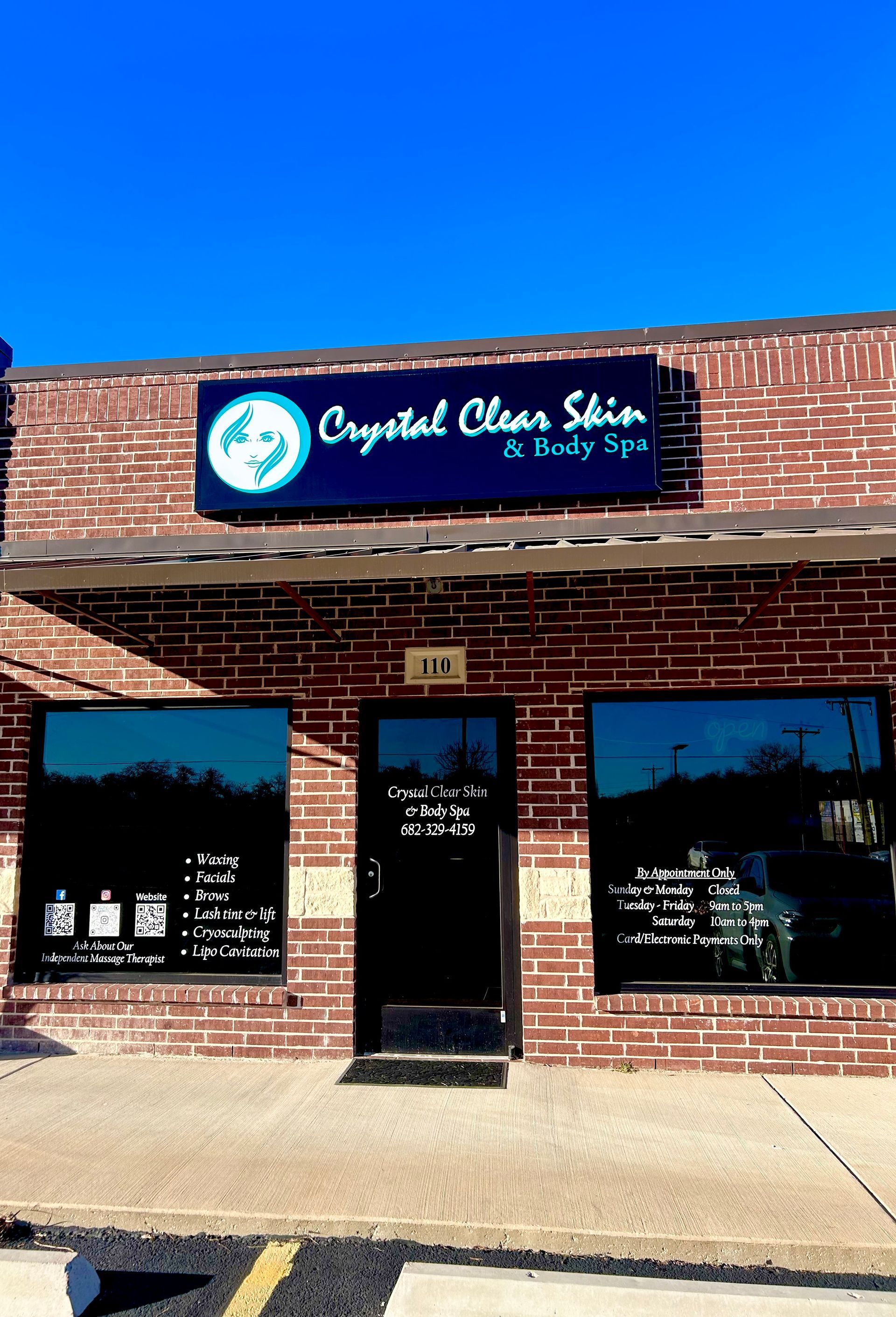 A brick building with a sign that says crystal clear skin