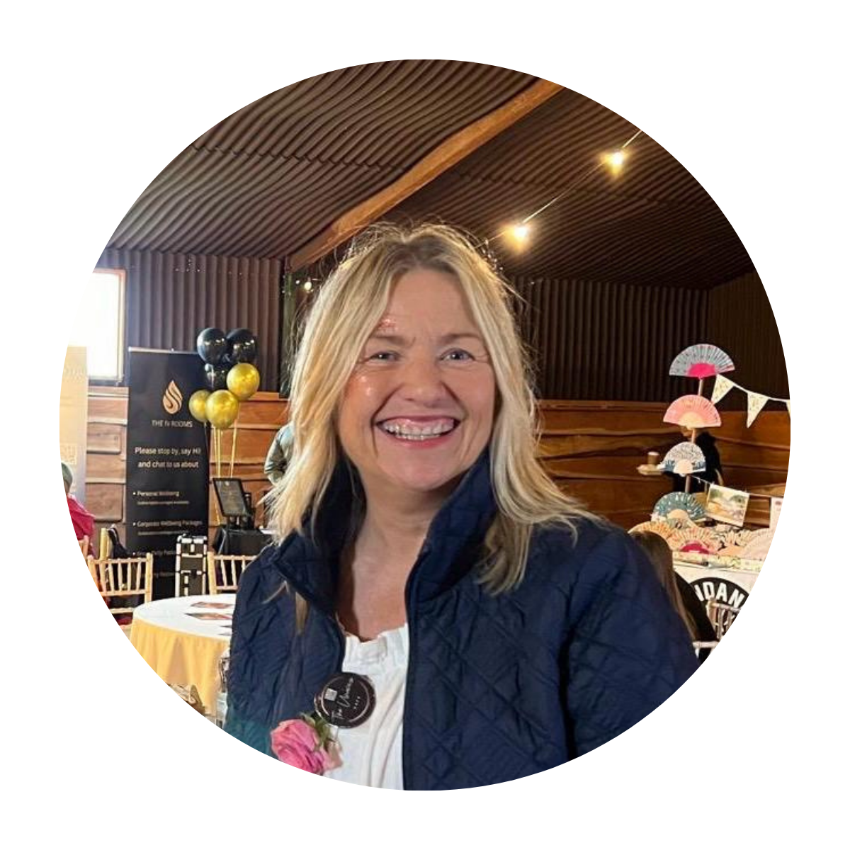 Pam Shanker in a blue jacket is smiling in a circle.
