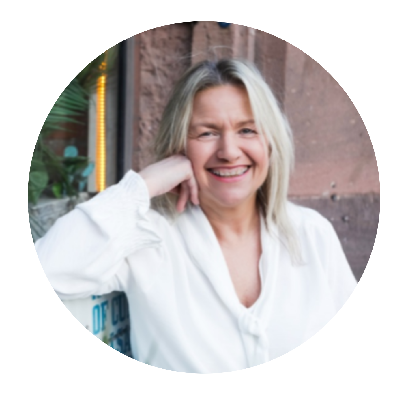Pam Shanker in a white shirt is smiling in a circle