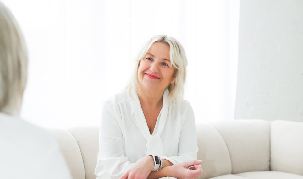 Pam Shanker in a blue jacket is smiling in a circle.