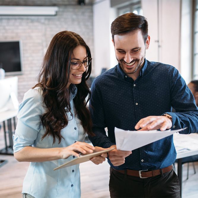 two employees looking at a document
