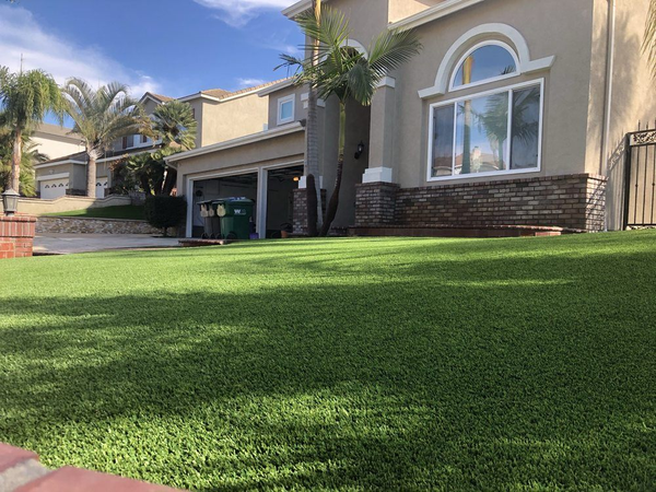 A large house with a lush green lawn in front of it.