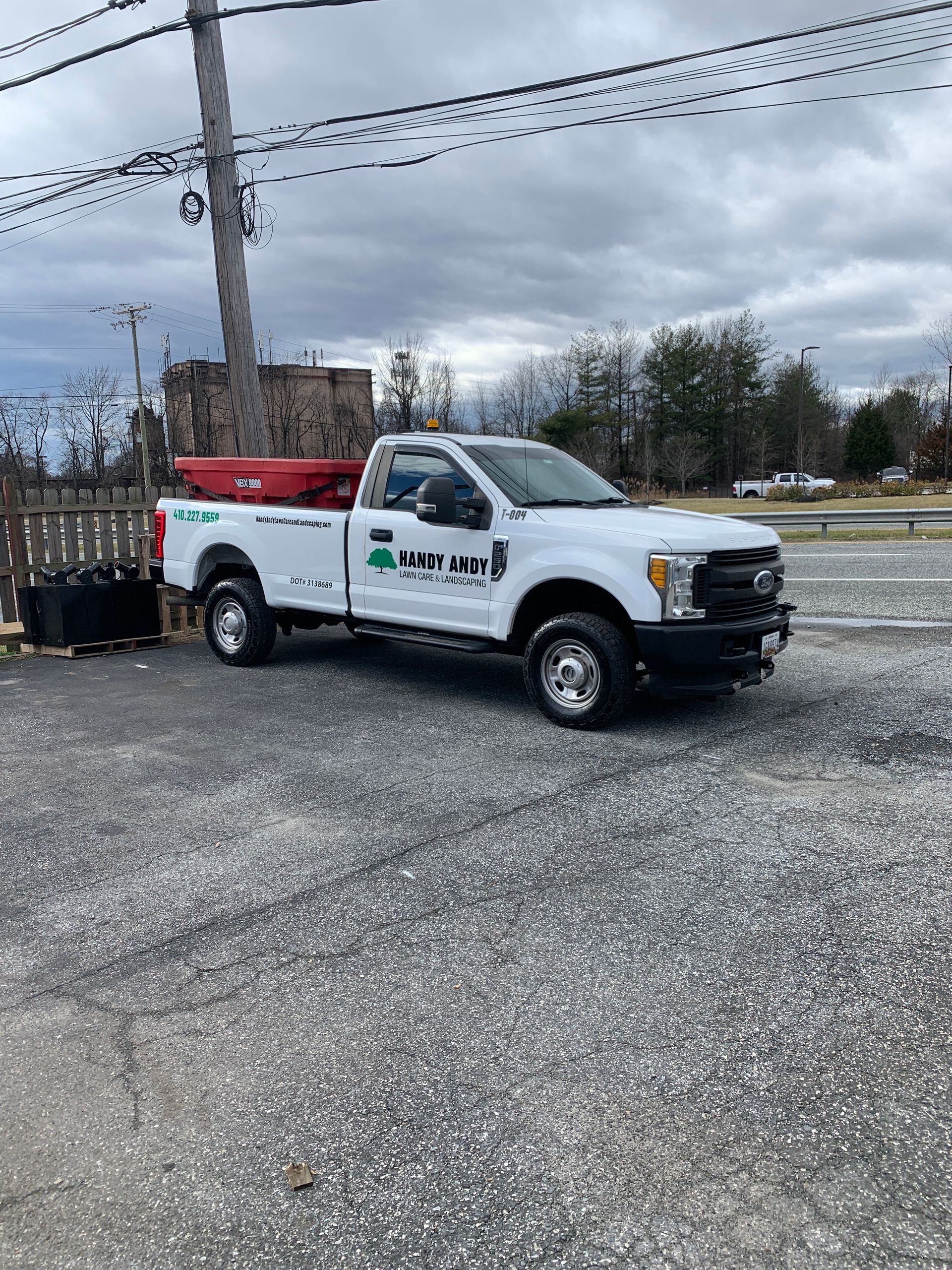 A white truck is parked on the side of the road.