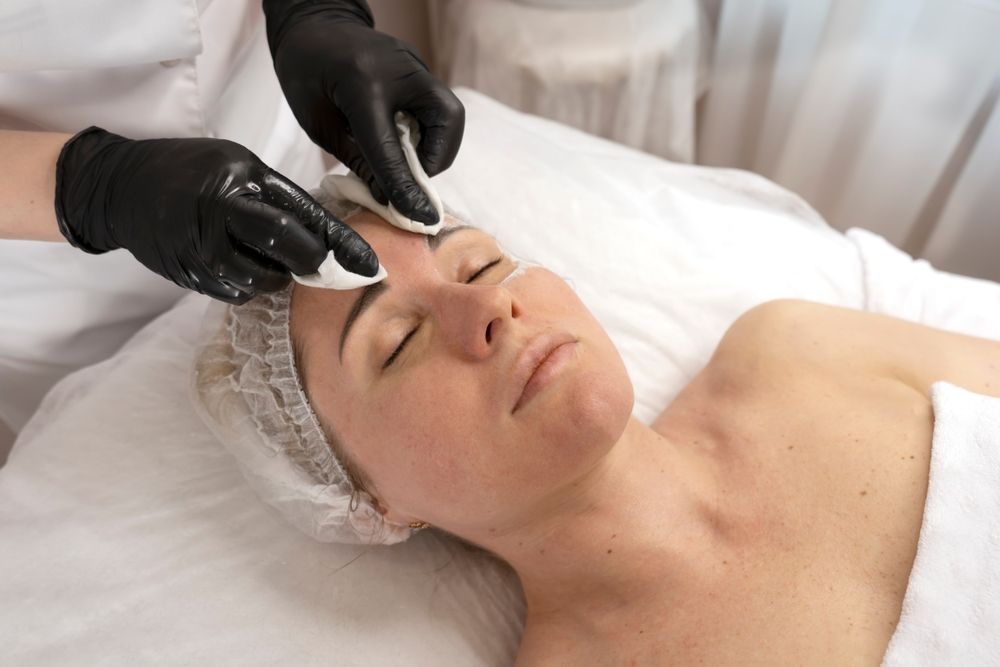 A Woman is Getting a Facial Treatment at a Spa — Gorjess Aesthetics in Corrimal, NSW
