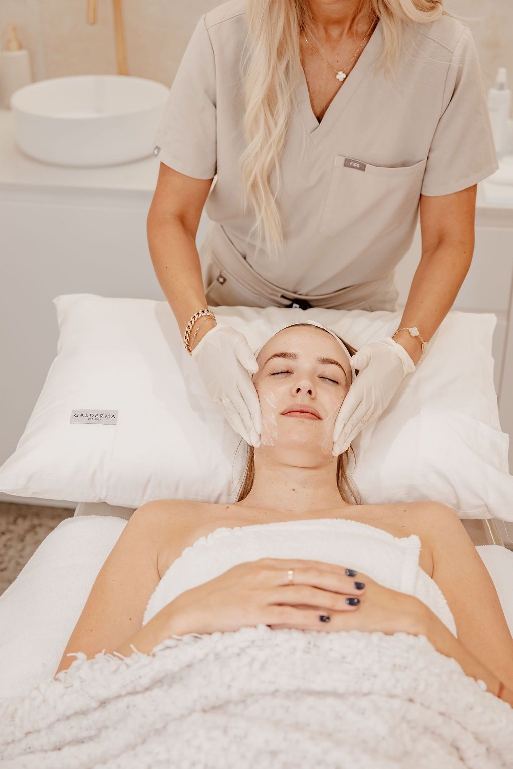 A Woman is Getting a Facial Treatment at a Spa — Gorjess Aesthetics in Corrimal, NSW