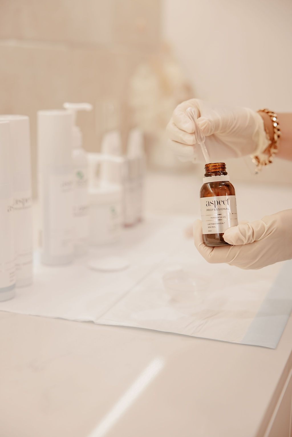 A Person is Holding a Bottle With a Pipette in Their Hand — Gorjess Aesthetics in Corrimal, NSW