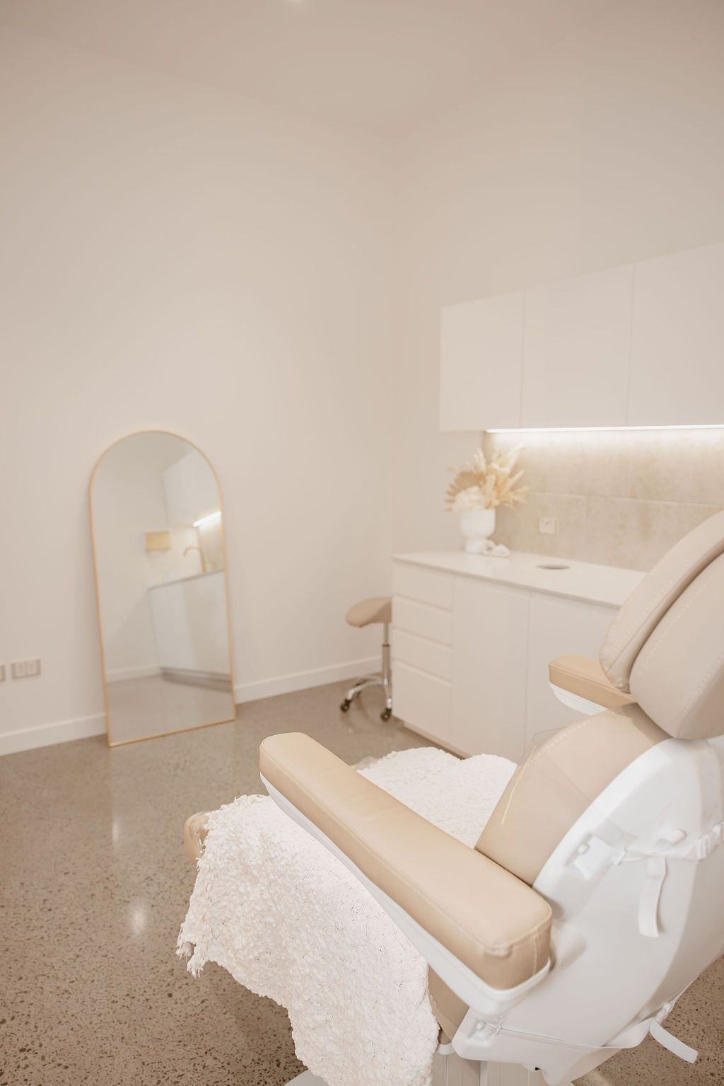 A Chair is Sitting in a Room Next to a Mirror — Gorjess Aesthetics in Corrimal, NSW