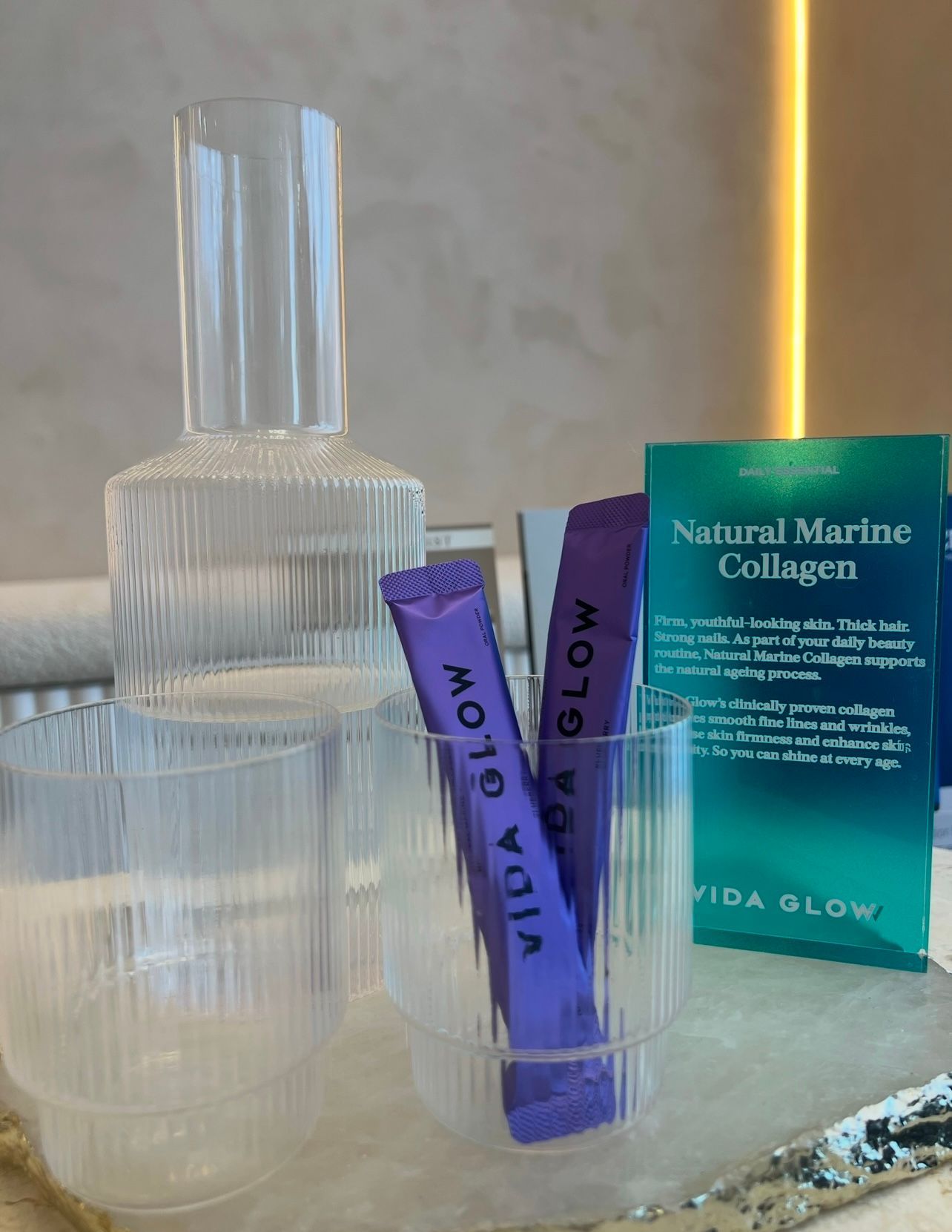 A Bottle of Vida Glow Natural Marine Collagen is Sitting on a Table — Gorjess Aesthetics in Corrimal, NSW