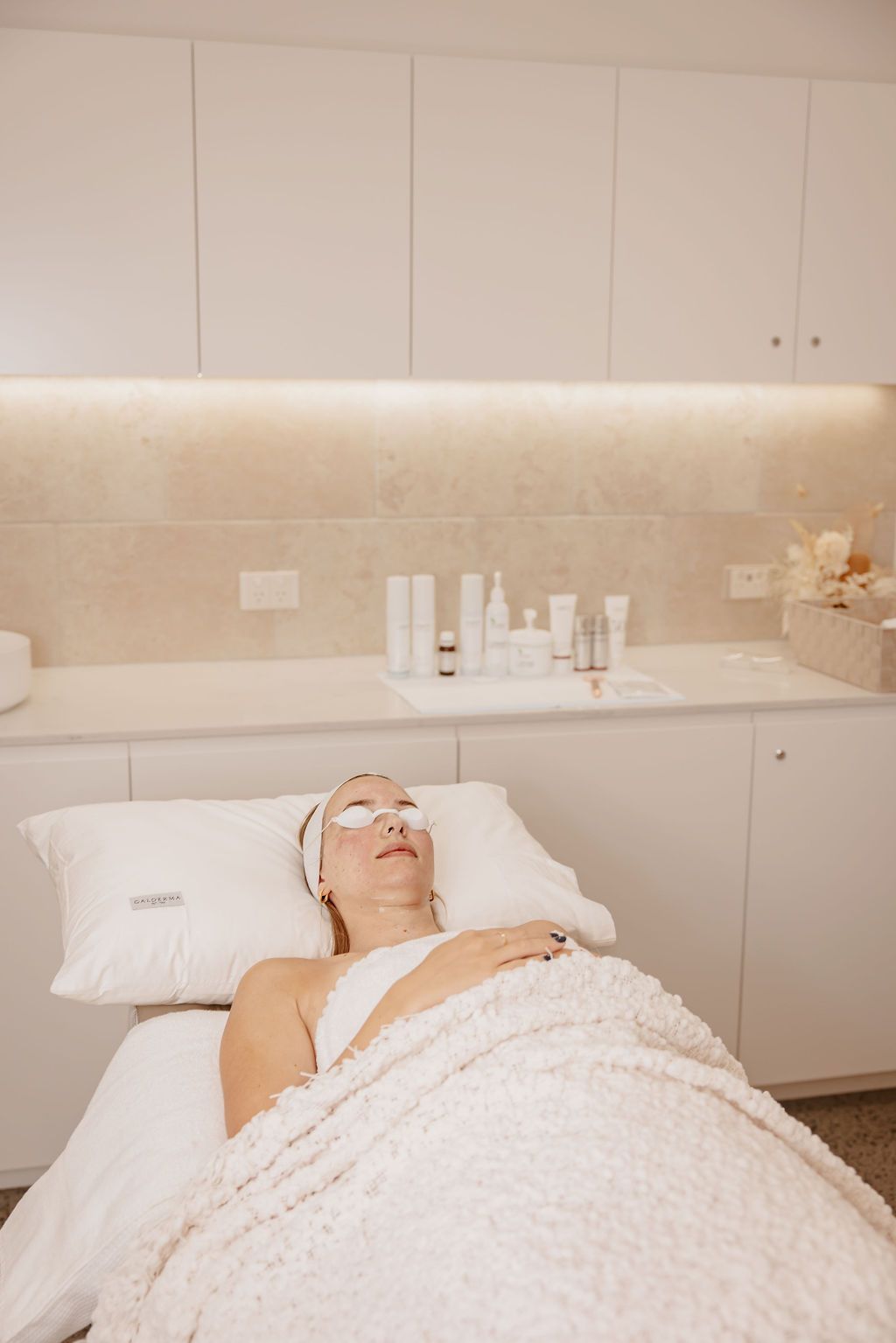 A Woman is Getting a Facial Treatment at a Spa — Gorjess Aesthetics in Corrimal, NSW