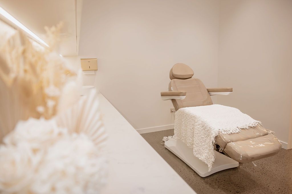 A Cosmetic Chair with A White Towel in A Room — Gorjess Aesthetics in Corrimal, NSW