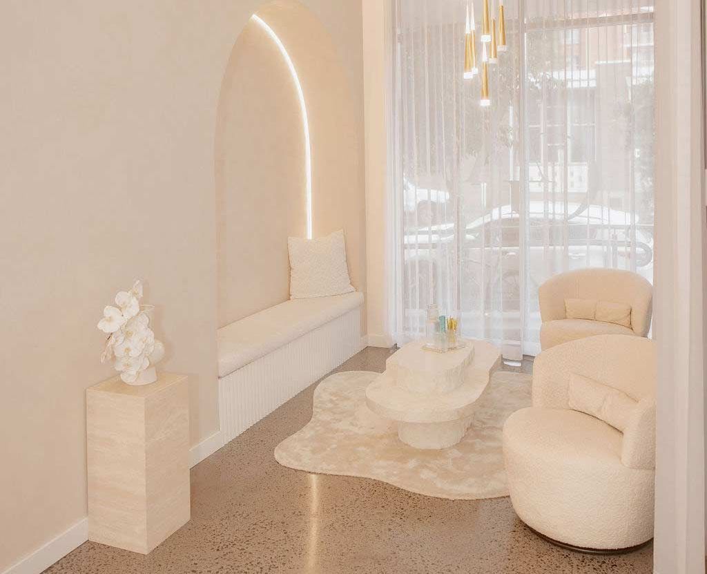 A Woman is Sitting on a Chair in a Room — Gorjess Aesthetics in Corrimal, NSW