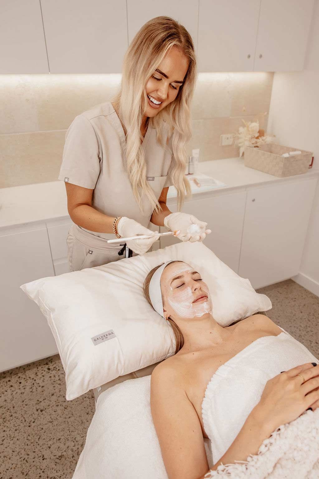 A Woman is Getting a Facial Treatment at a Beauty Salon — Gorjess Aesthetics in Corrimal, NSW