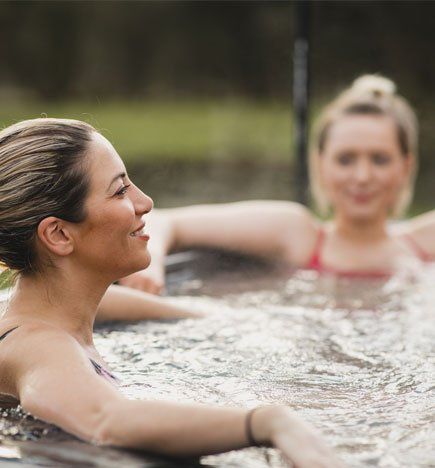 Women Relaxing in Hot Tub — Portage, MI — Michigan Swim Pool & Spa