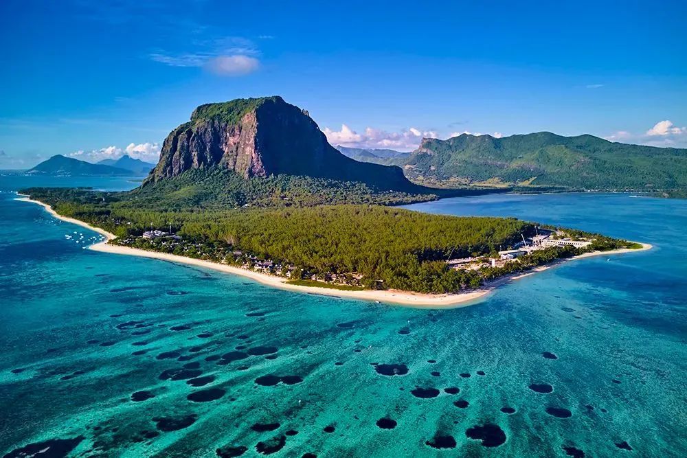 An aerial view of a small island in the middle of the ocean.