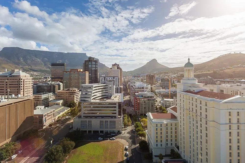 An aerial view of a city with mountains in the background.