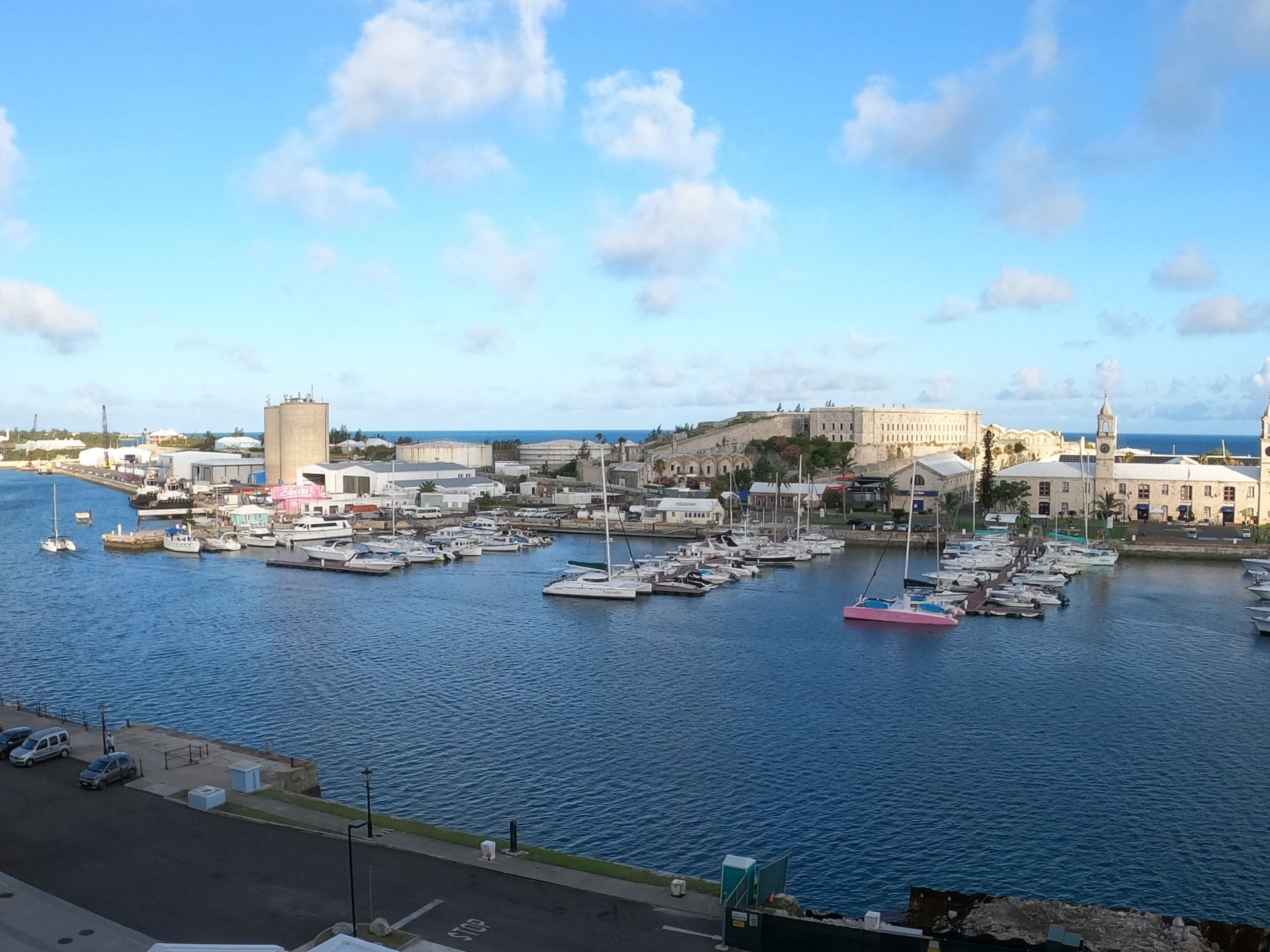 Harbor with boats, buildings, and a cloudy sky, likely Bermuda.