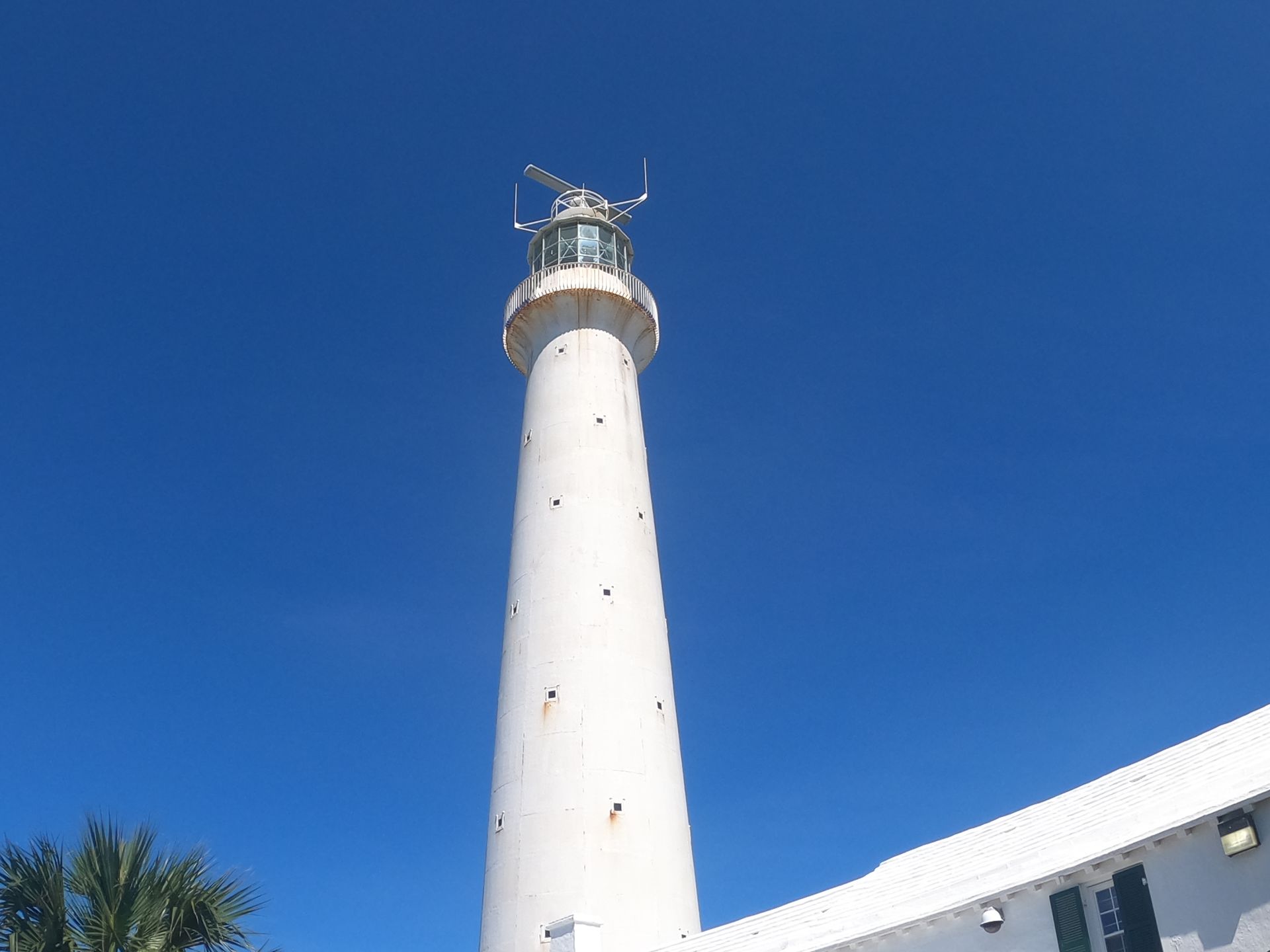 White lighthouse against a clear blue sky.