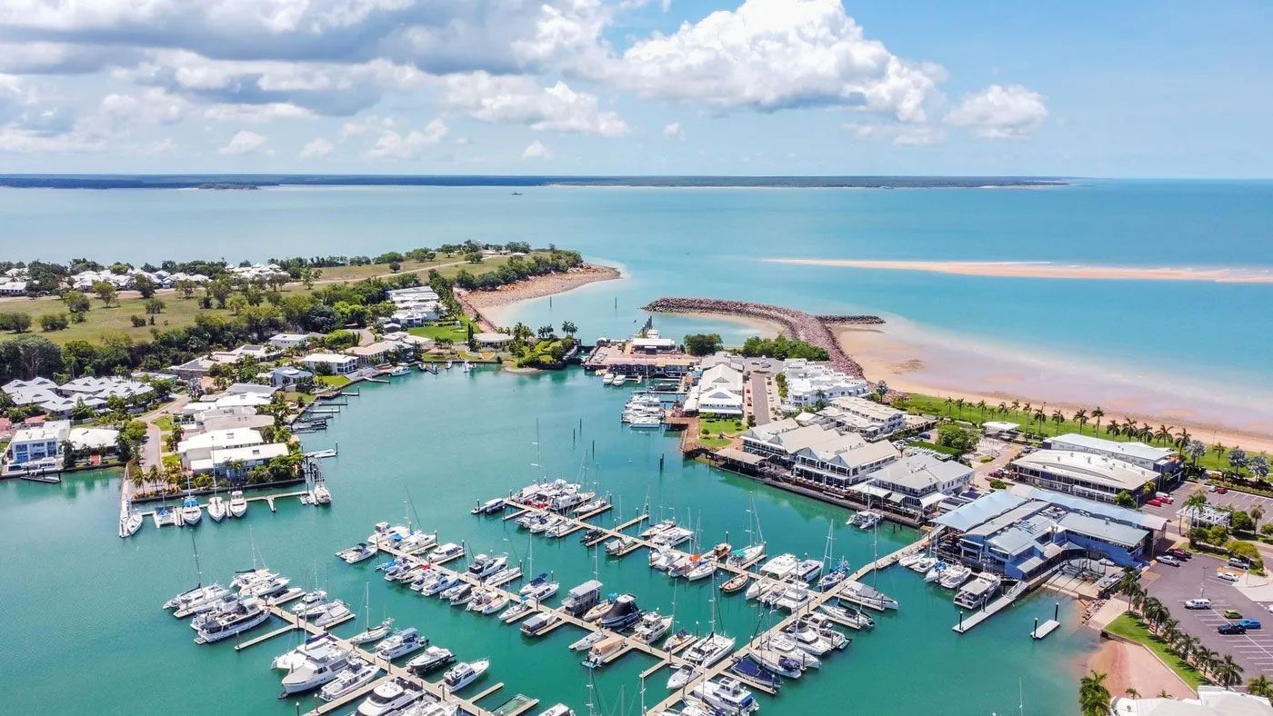 An aerial view of a marina with boats docked in the water.