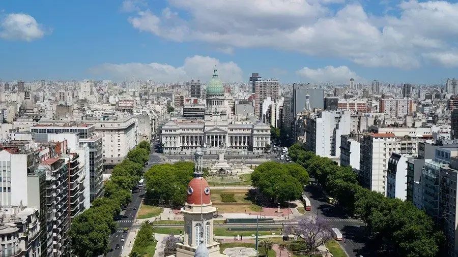 An aerial view of a city with lots of buildings and trees