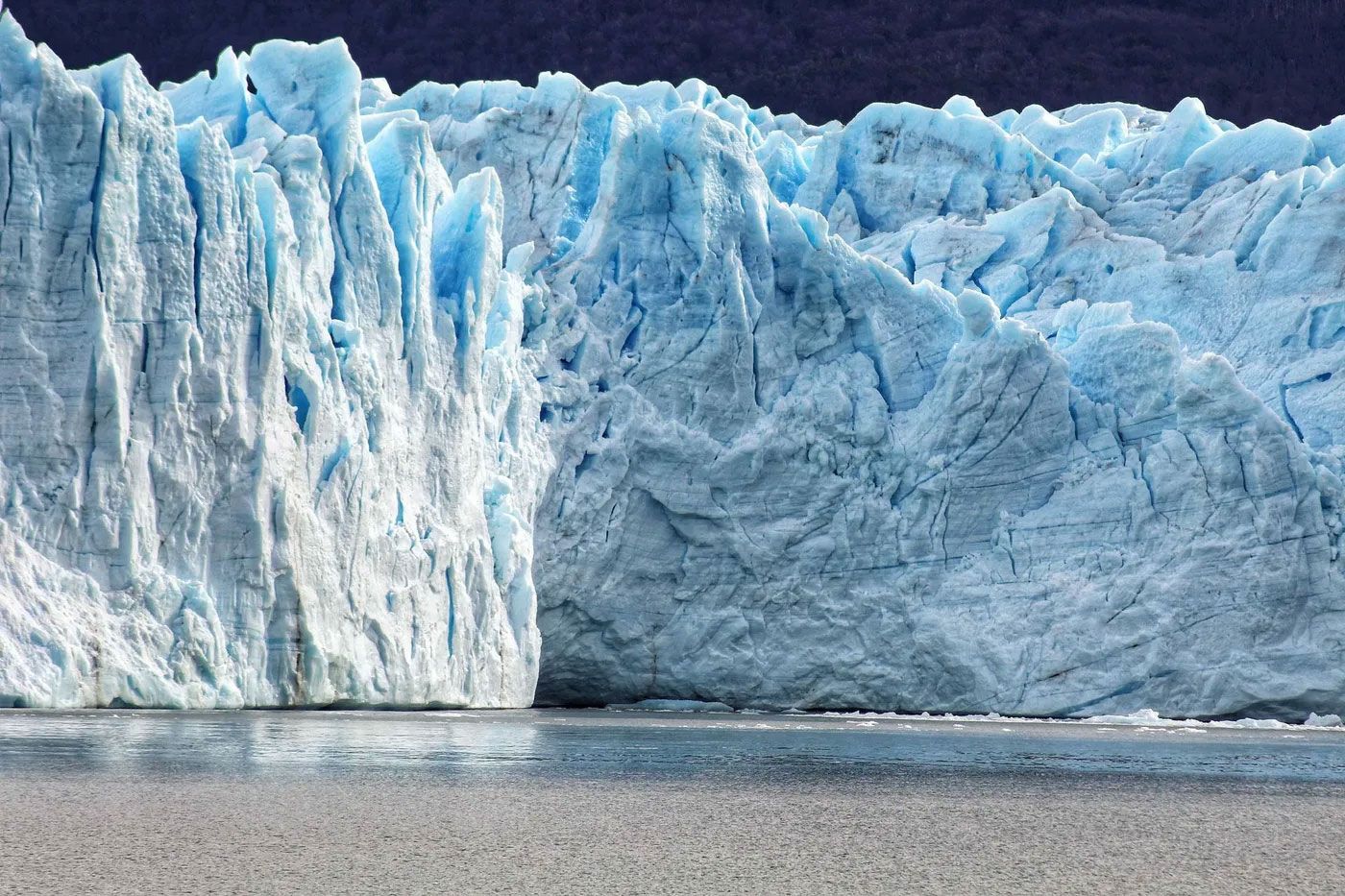 A large iceberg is sitting in the middle of a body of water