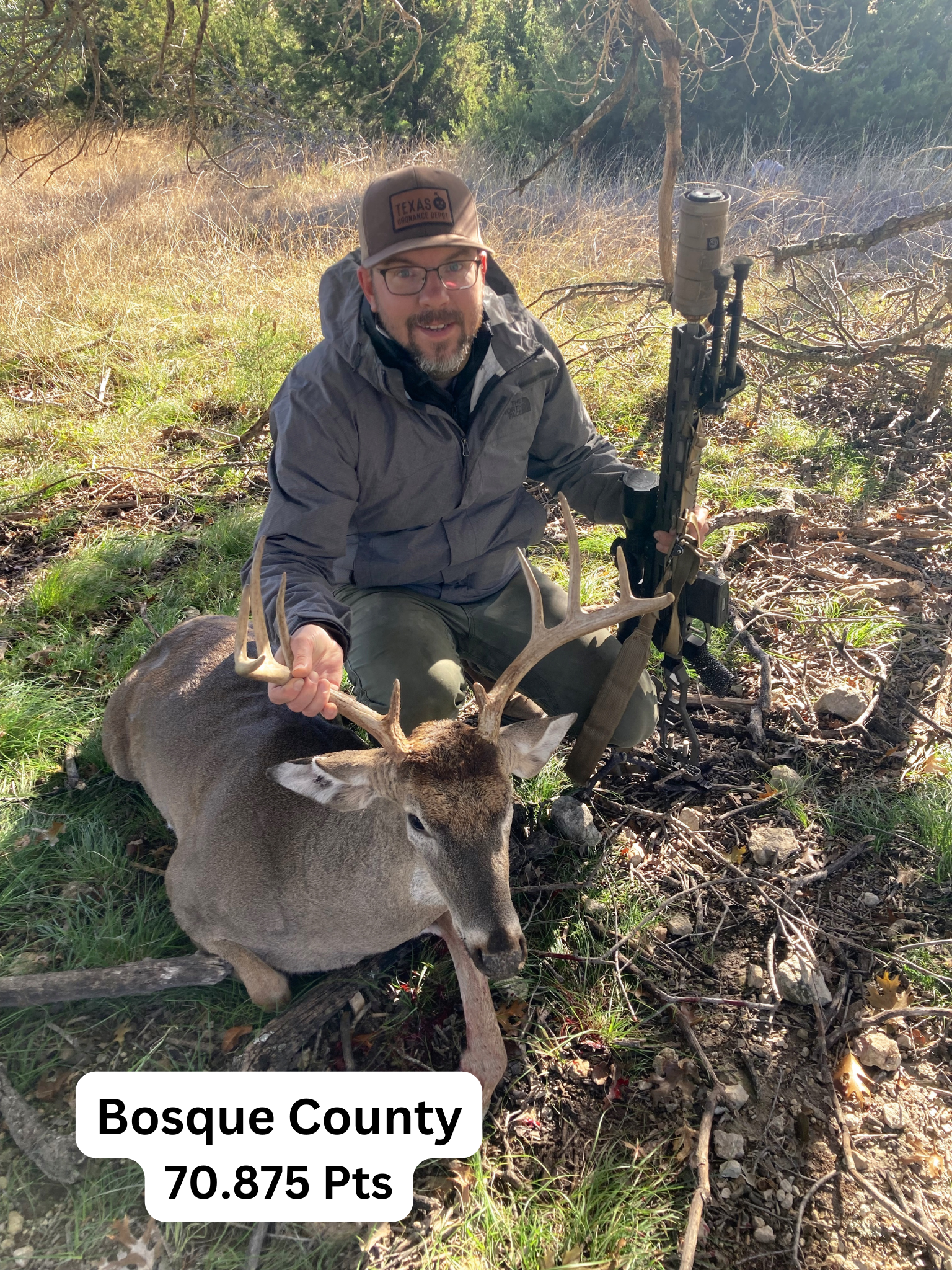 Man kneeling next to a buck he has just hunted in Bosque County, Texas. 70.875 Pts.