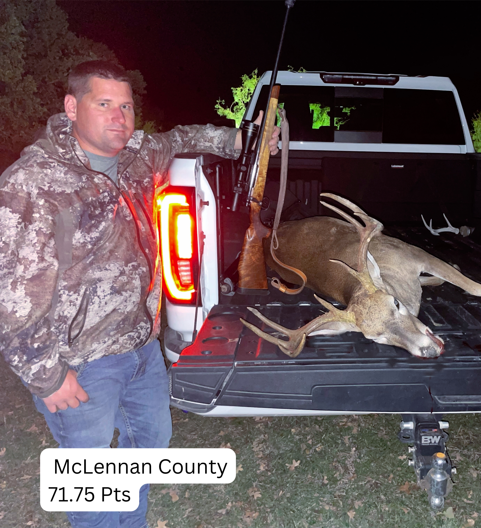 Man in camo jacket with a buck in a truck bed, McLennan County.