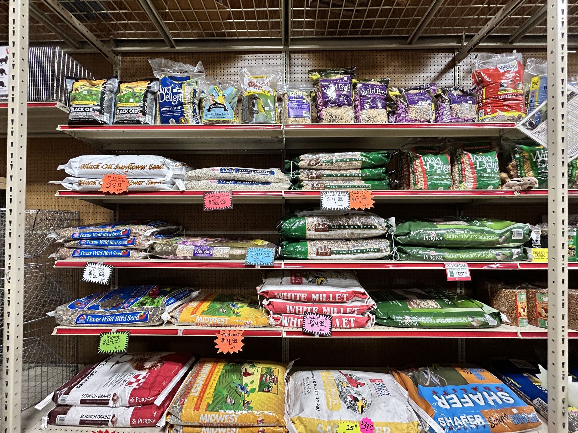 A shelf in a store filled with lots of bags of food.