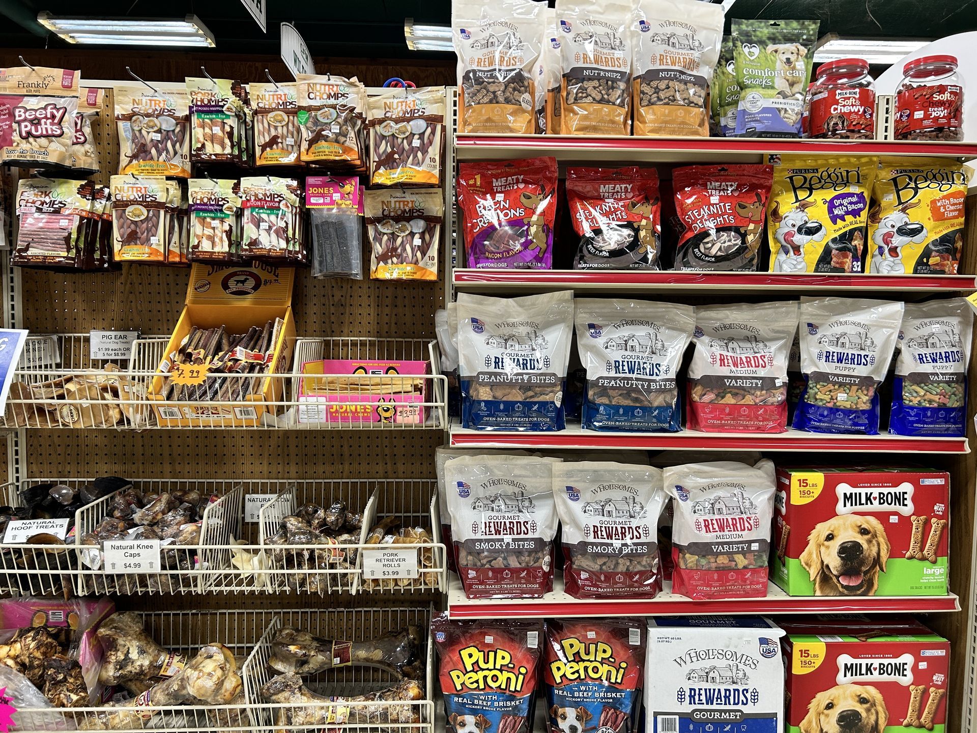 There are many different types of dog food on the shelves in this store.