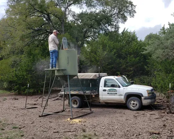 Man Beside Tank — Clifton, TX — Clifton Feed and Service