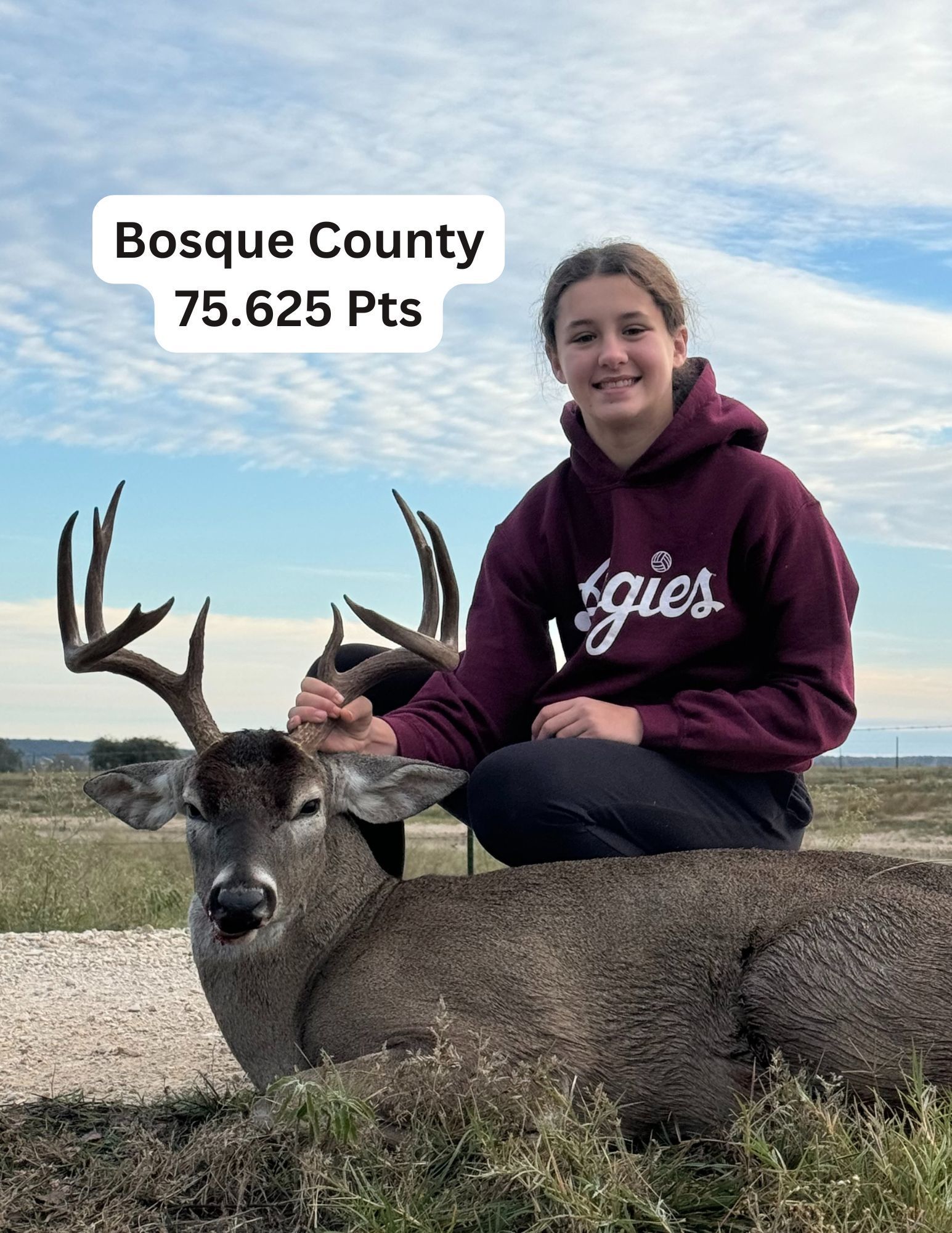 A young woman smiles, sitting with a harvested deer in Bosque County, Texas. The deer scored 75.625 points.